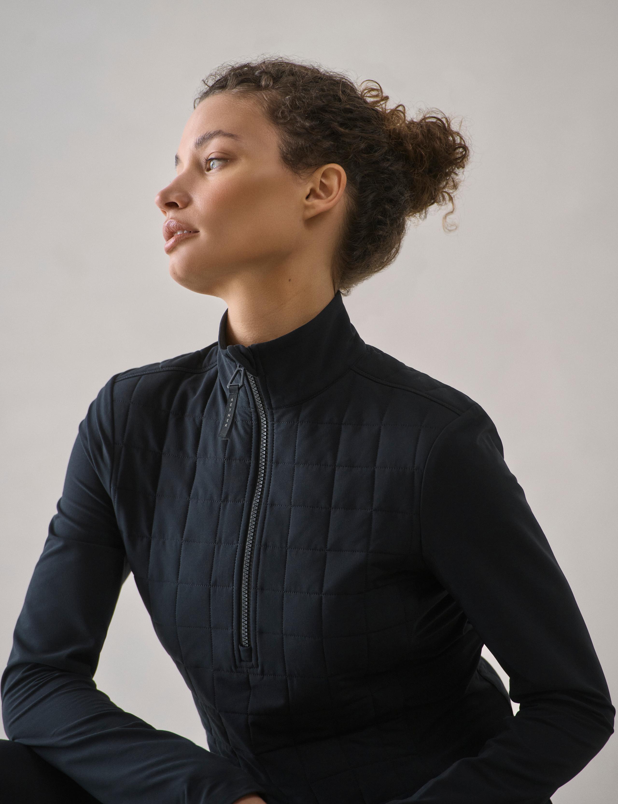 Closeup of woman wearing the Wren Insulated Half-Zip in Onyx Black