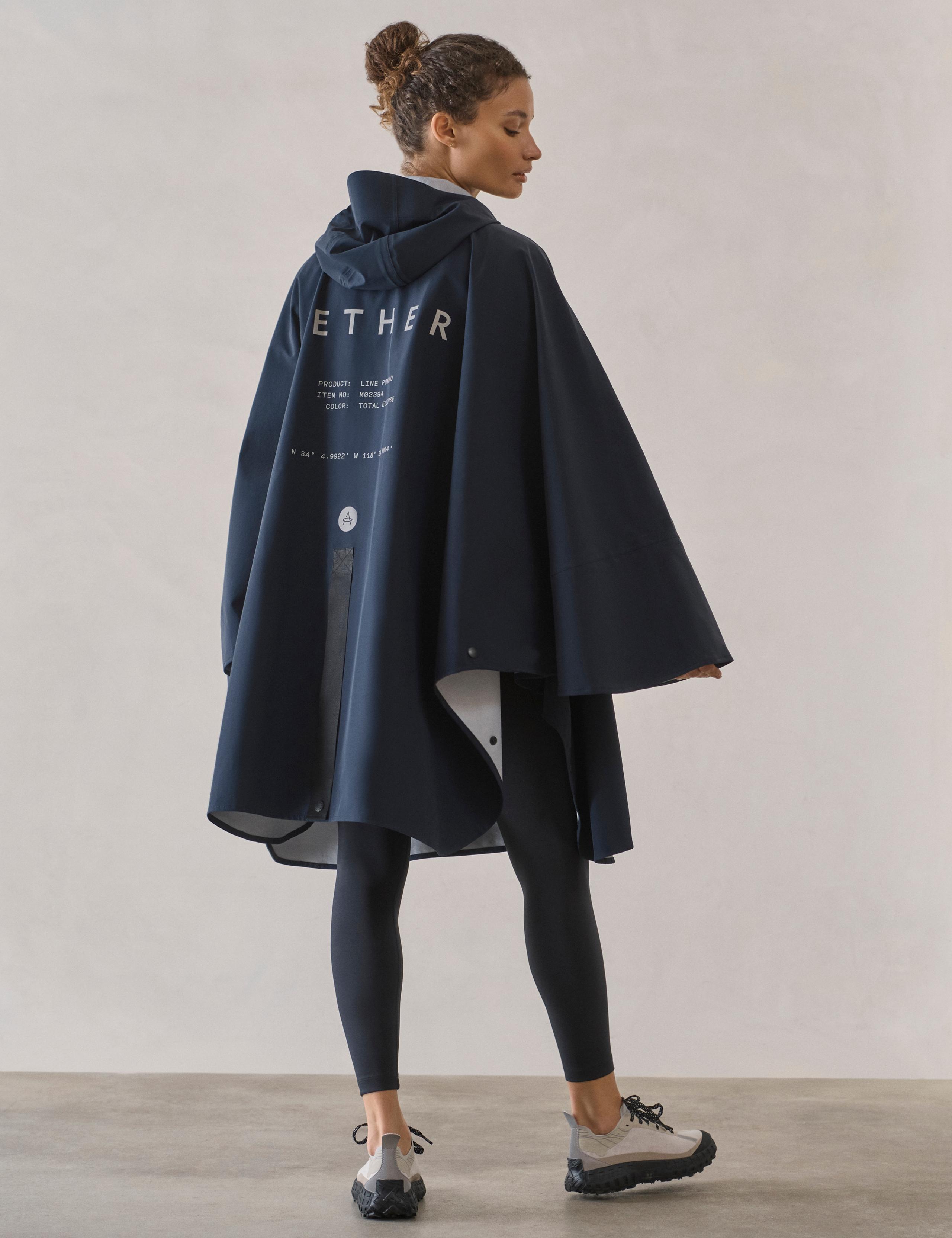 Woman wearing the Line Rain Poncho in Total Eclipse