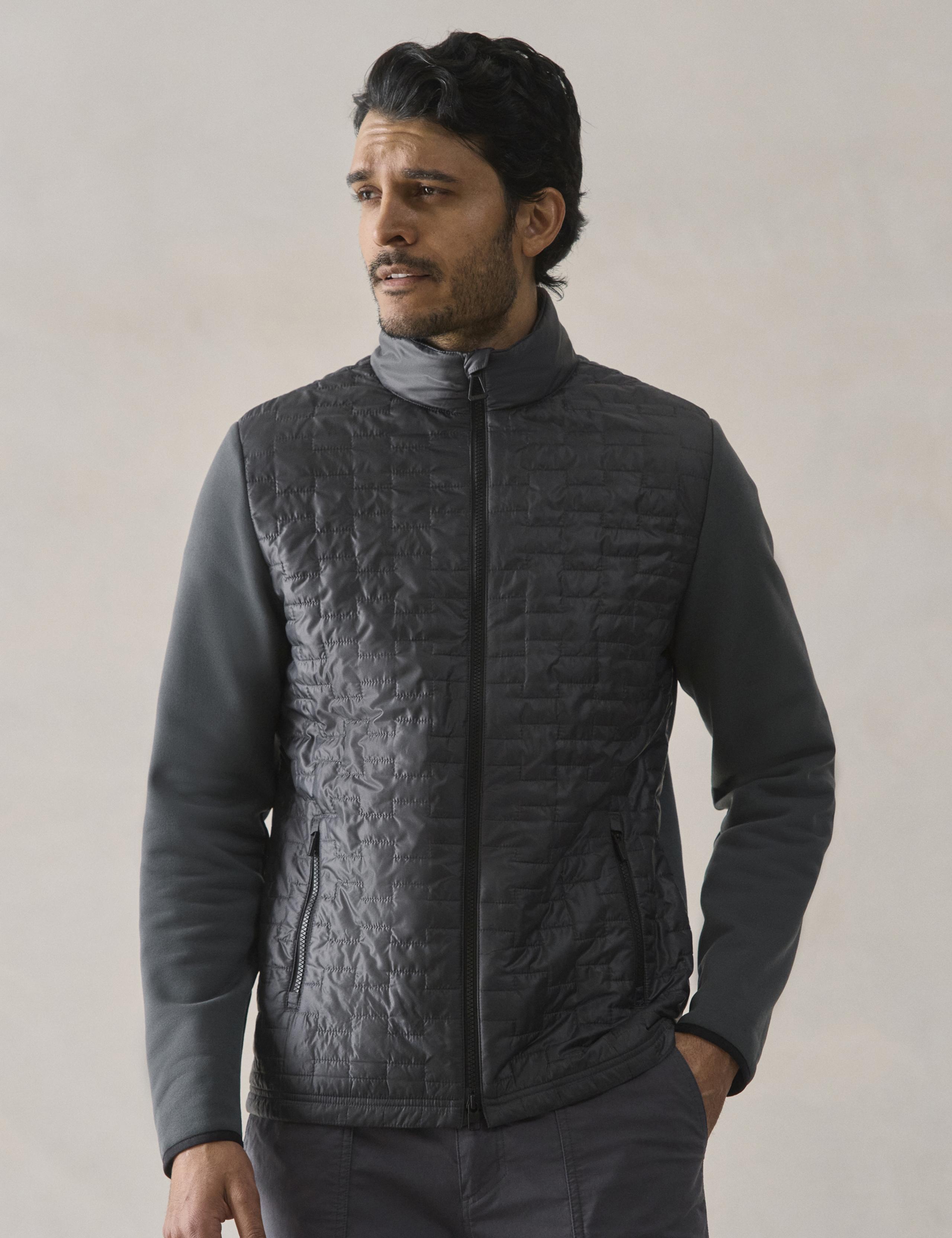 Man in studio wearing the Hybrid Tech Full-Zip in Graphite
