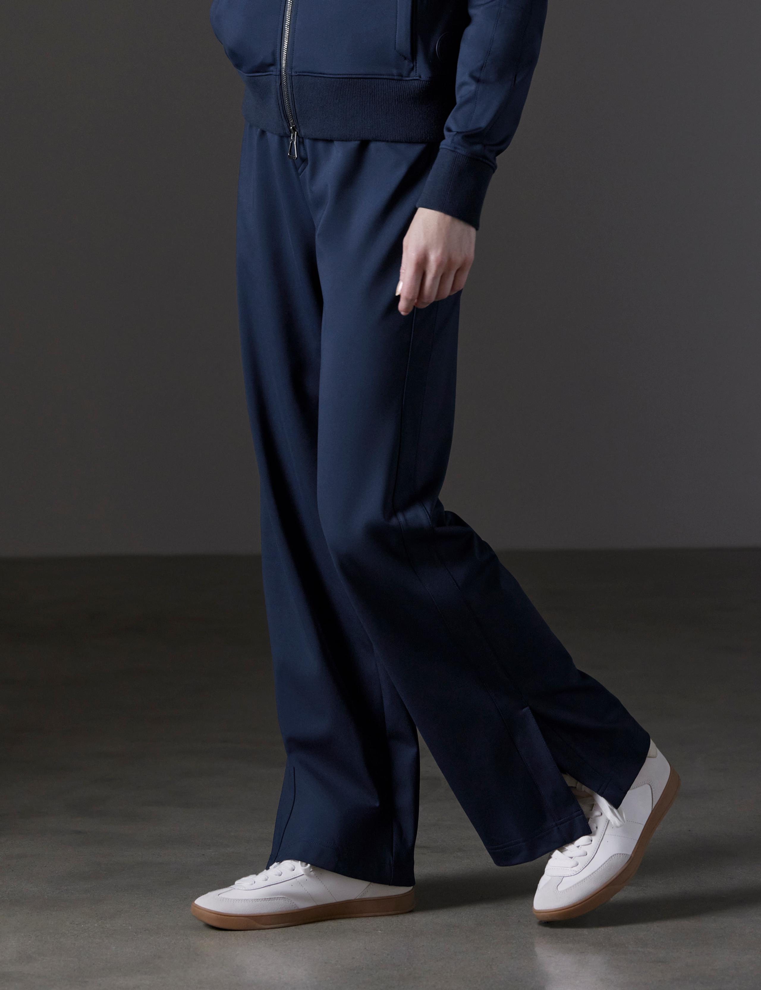 Woman in studio wearing of Eloise Travel Pant in Total Eclipse