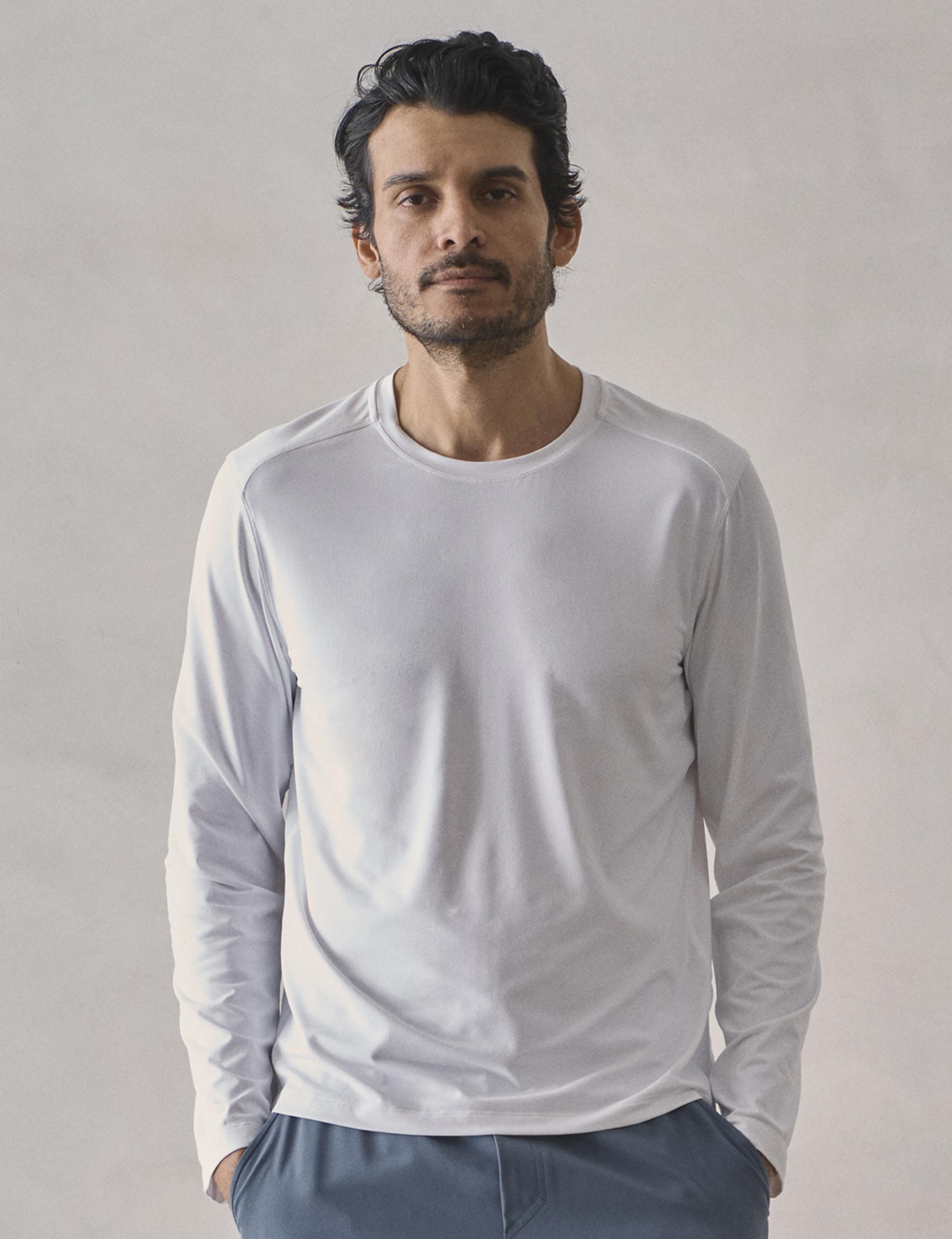 Man in studio wearing the Adventure Performance Long-Sleeve Tee in White