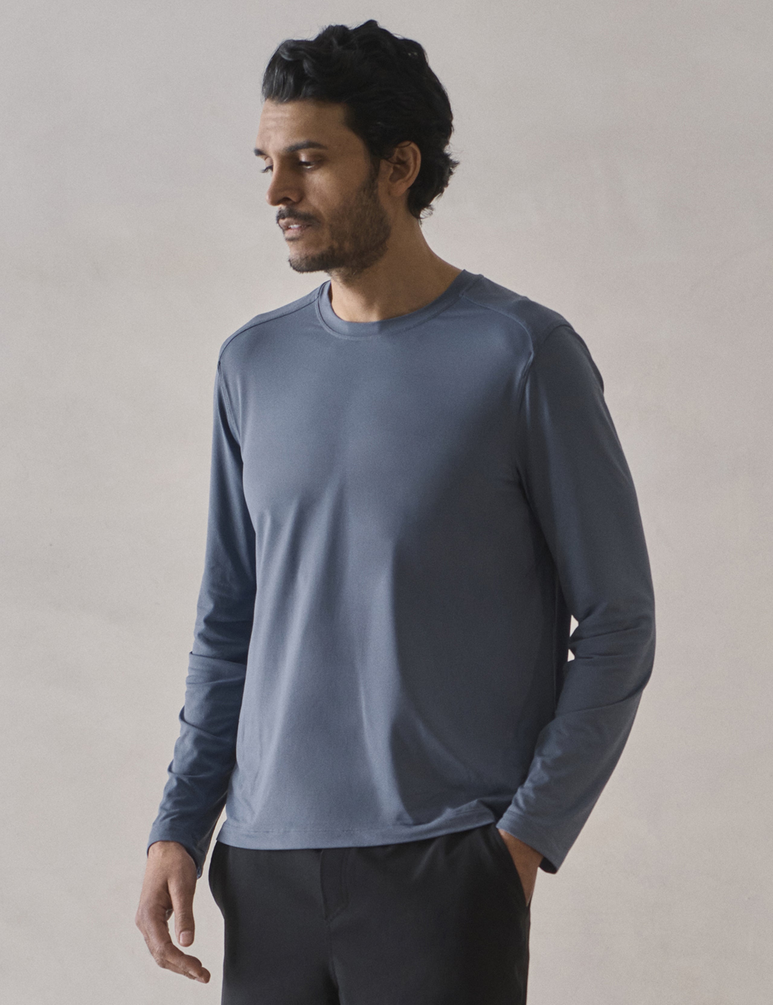 Front 3/4 upper-body view of man wearing Adventure Performance Long-Sleeve Tee in Portal Blue from AETHER Apparel.