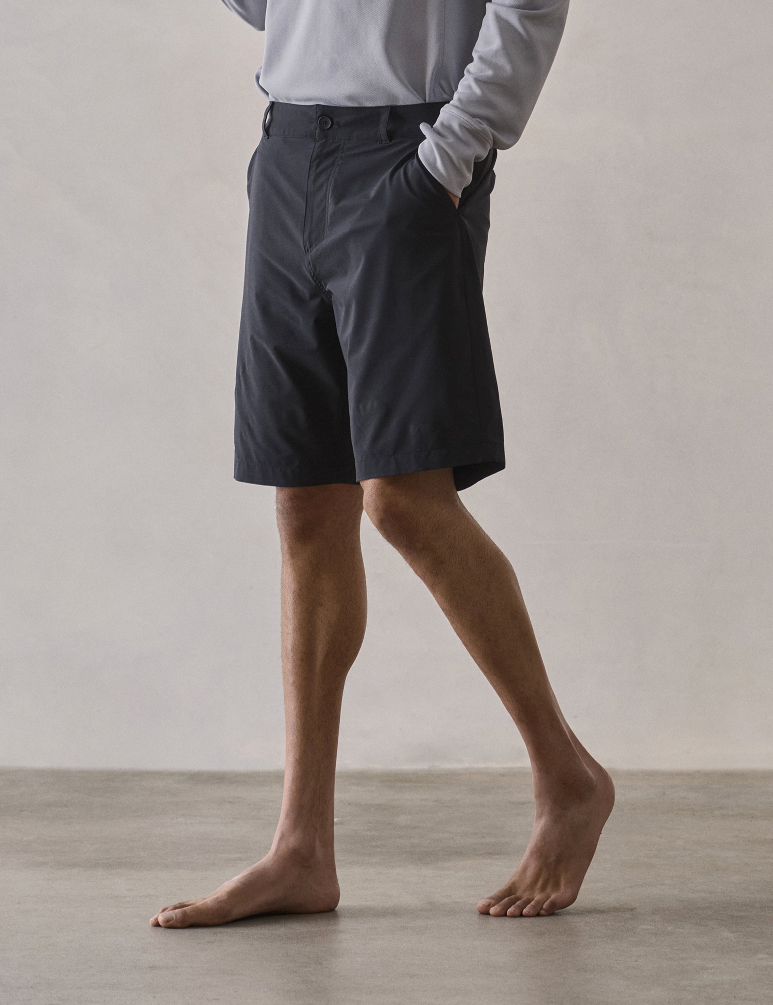 Front 3/4 lower-body view of man wearing Catalina Submersible Short in Onyx Black from AETHER Apparel.