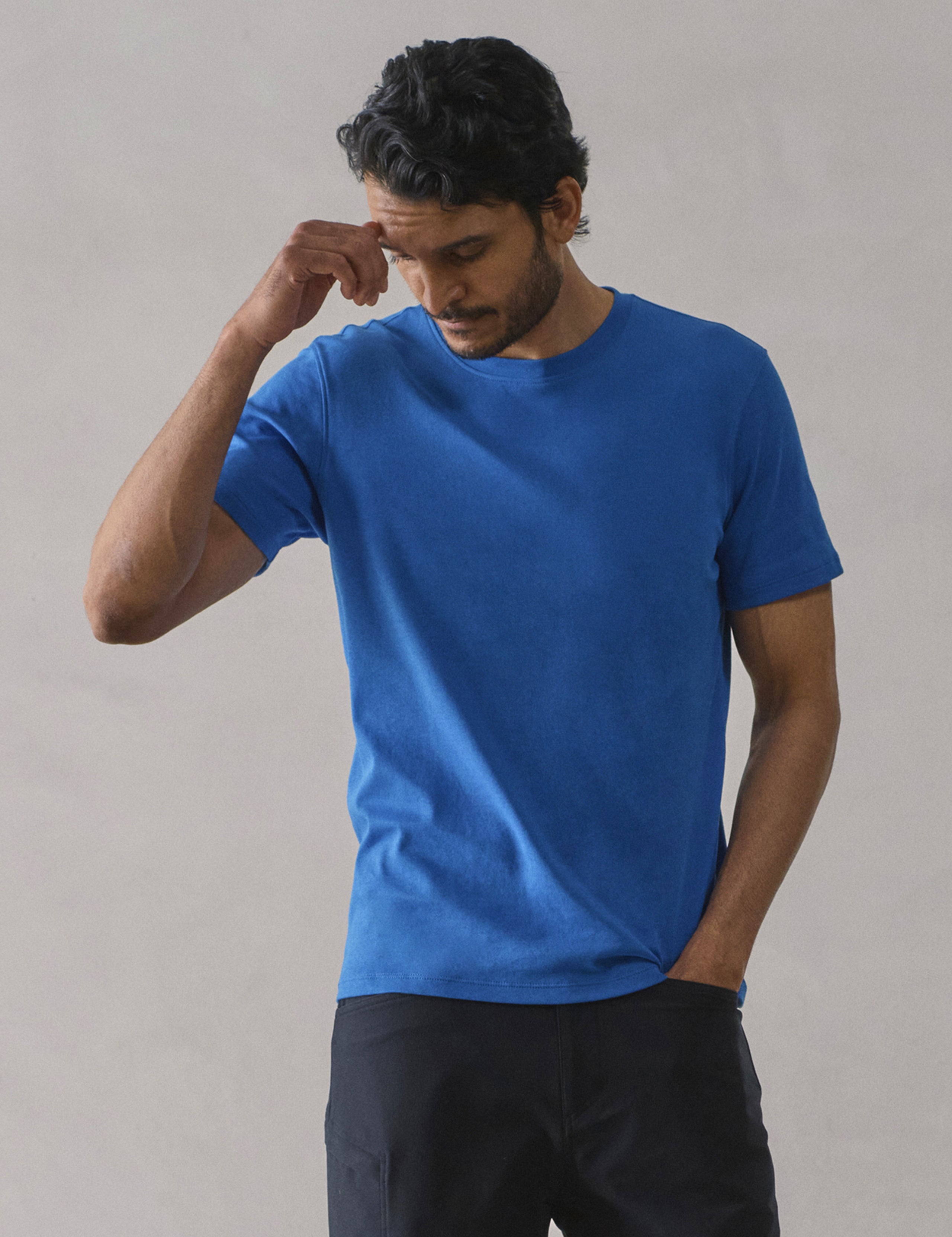 Front view of man wearing Emery Pima Crew Tee in Summit Blue from AETHER Apparel.