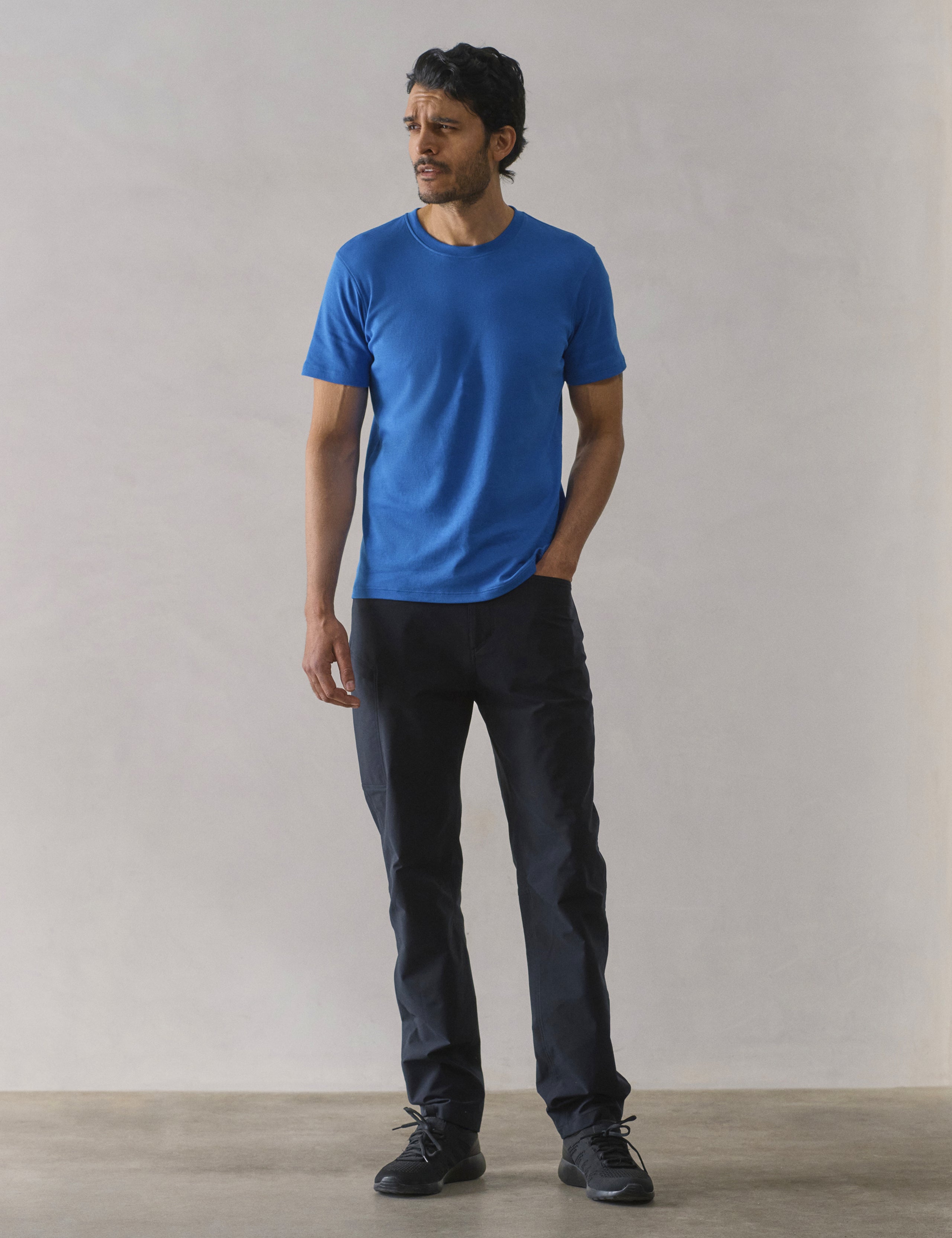Front full-body view of man wearing Emery Pima Crew Tee in Summit Blue from AETHER Apparel.