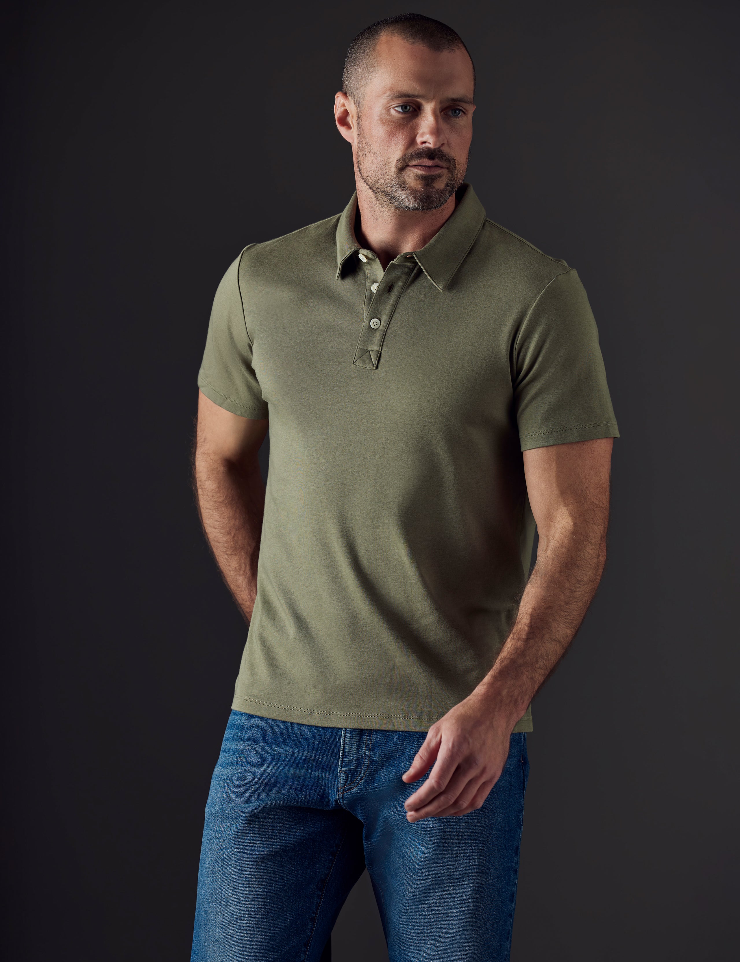 Front body view of man wearing Emery Pima Polo in Fern Green from AETHER Apparel.