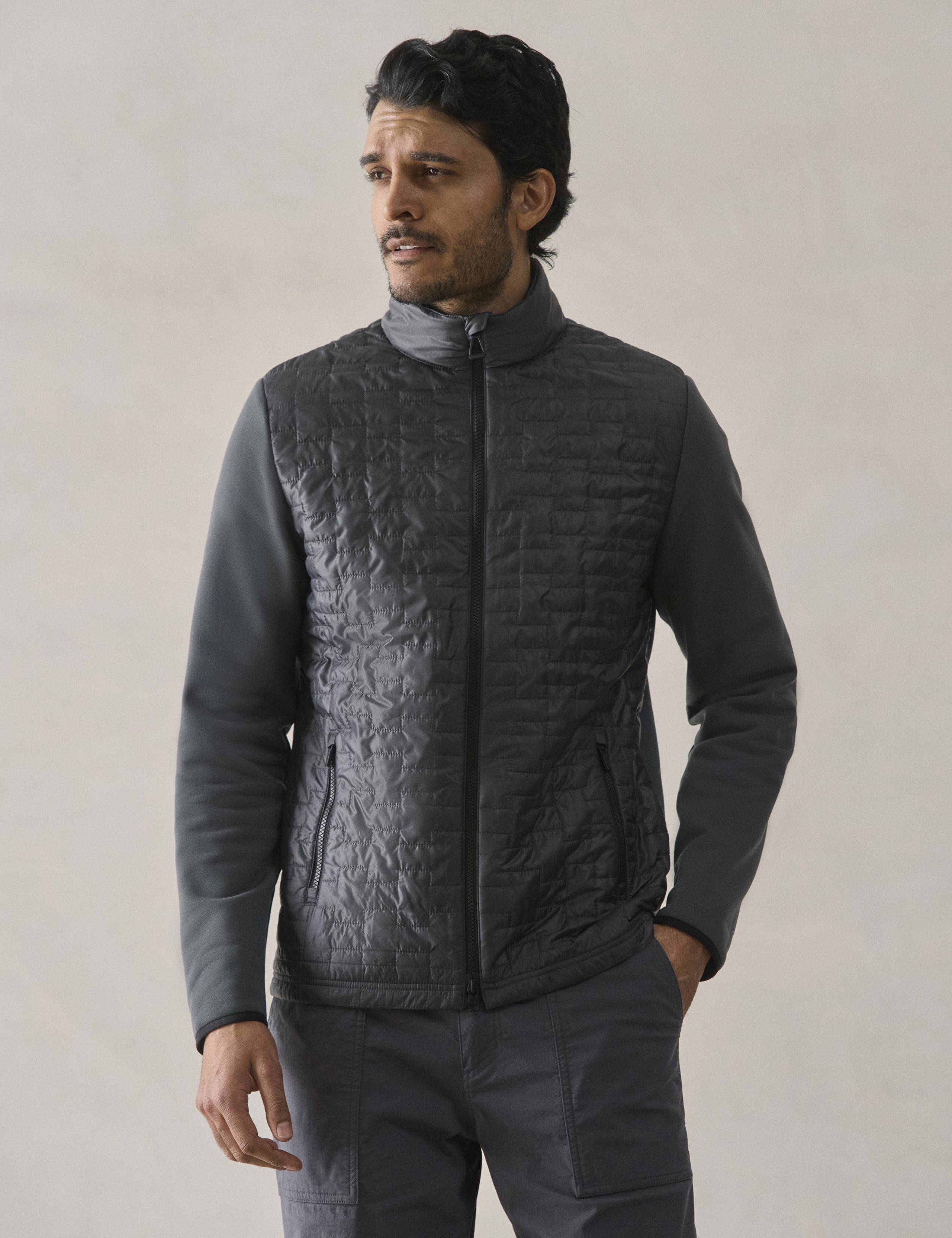 Front upper body view of man wearing Hybrid Tech Full-Zip in Graphite from AETHER Apparel.