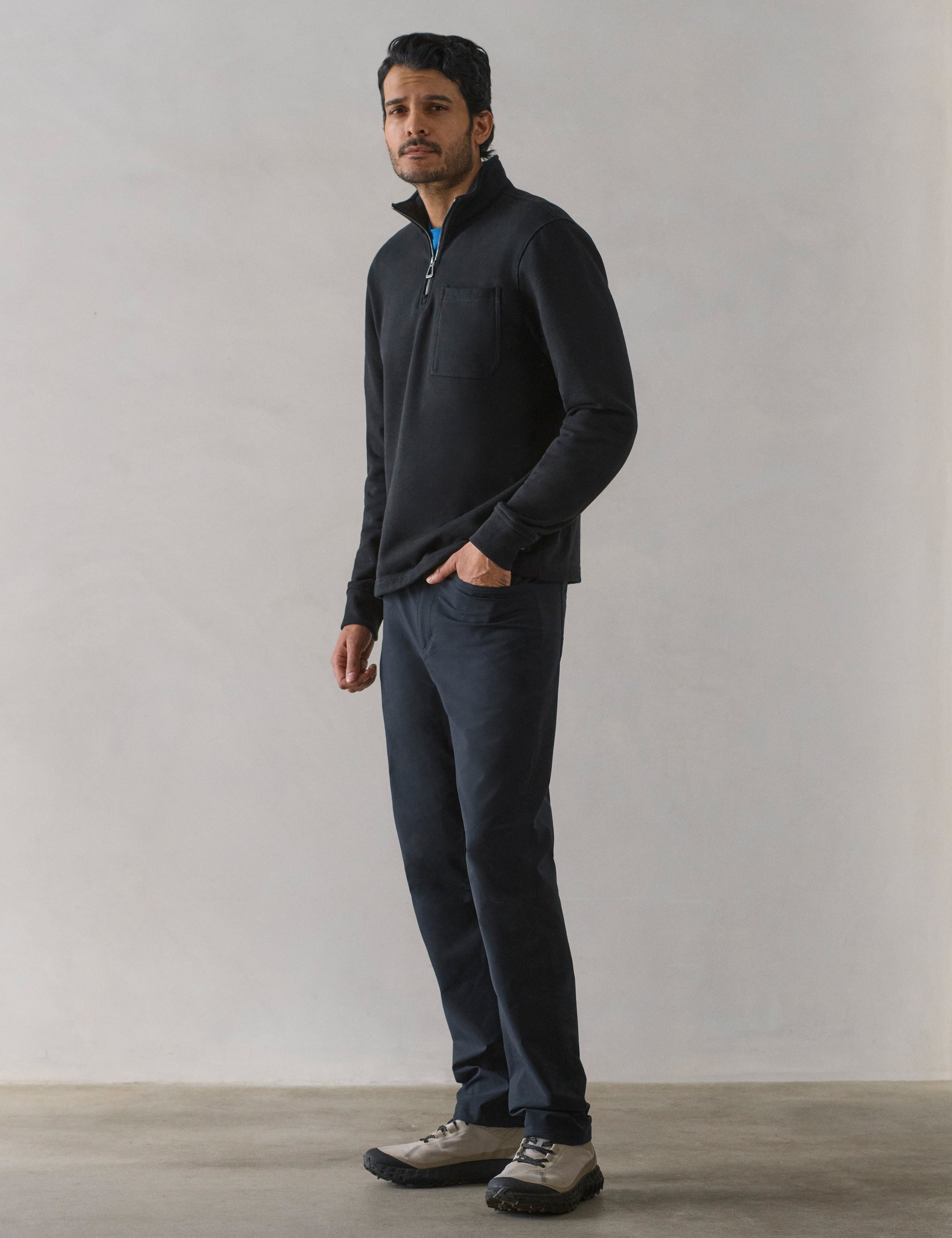 Front 3/4 full-body view of man wearing Monte Half-Zip Sweatshirt in Onyx Black from AETHER Apparel.