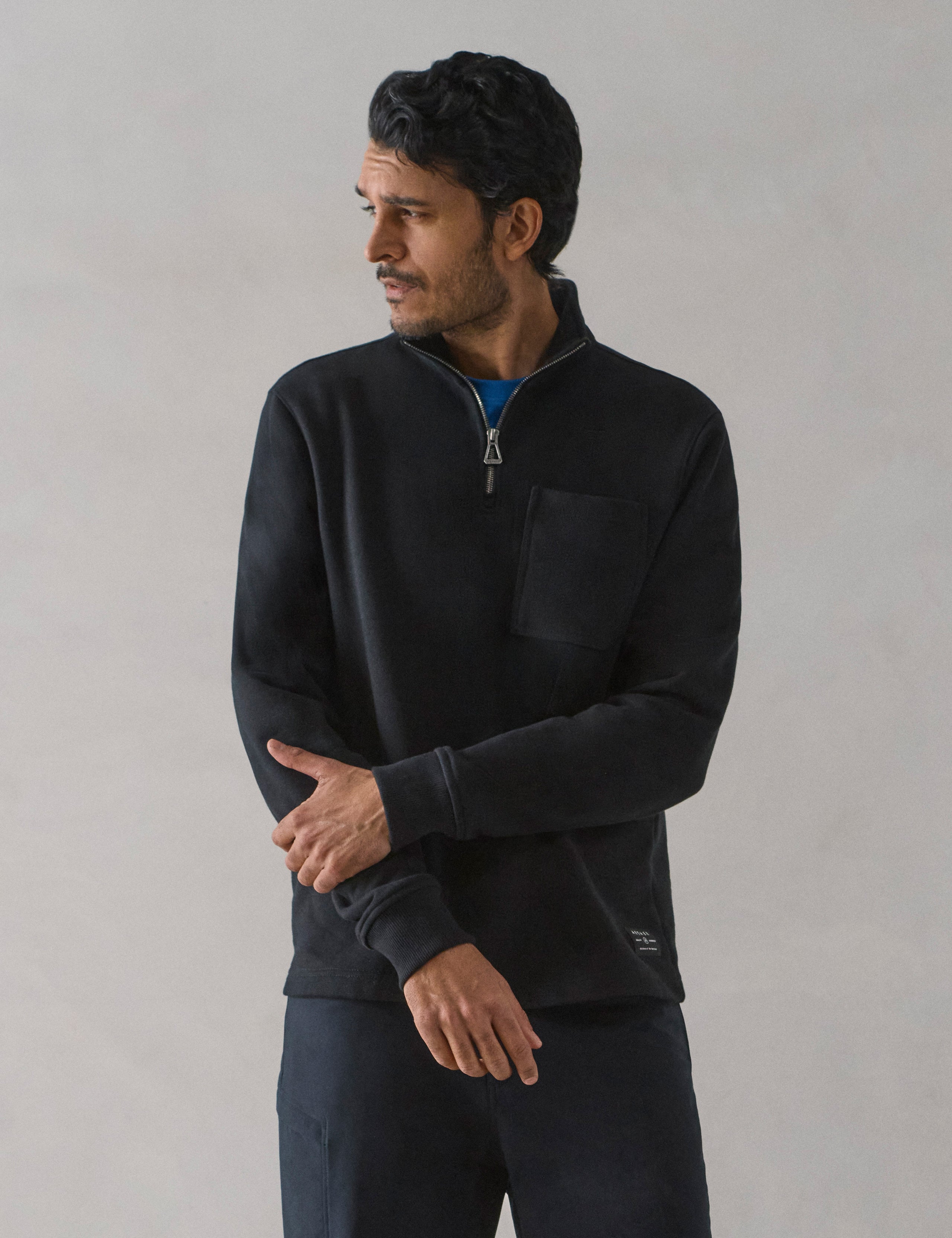 Front body view of man wearing Monte Half-Zip Sweatshirt in Onyx Black from AETHER Apparel.