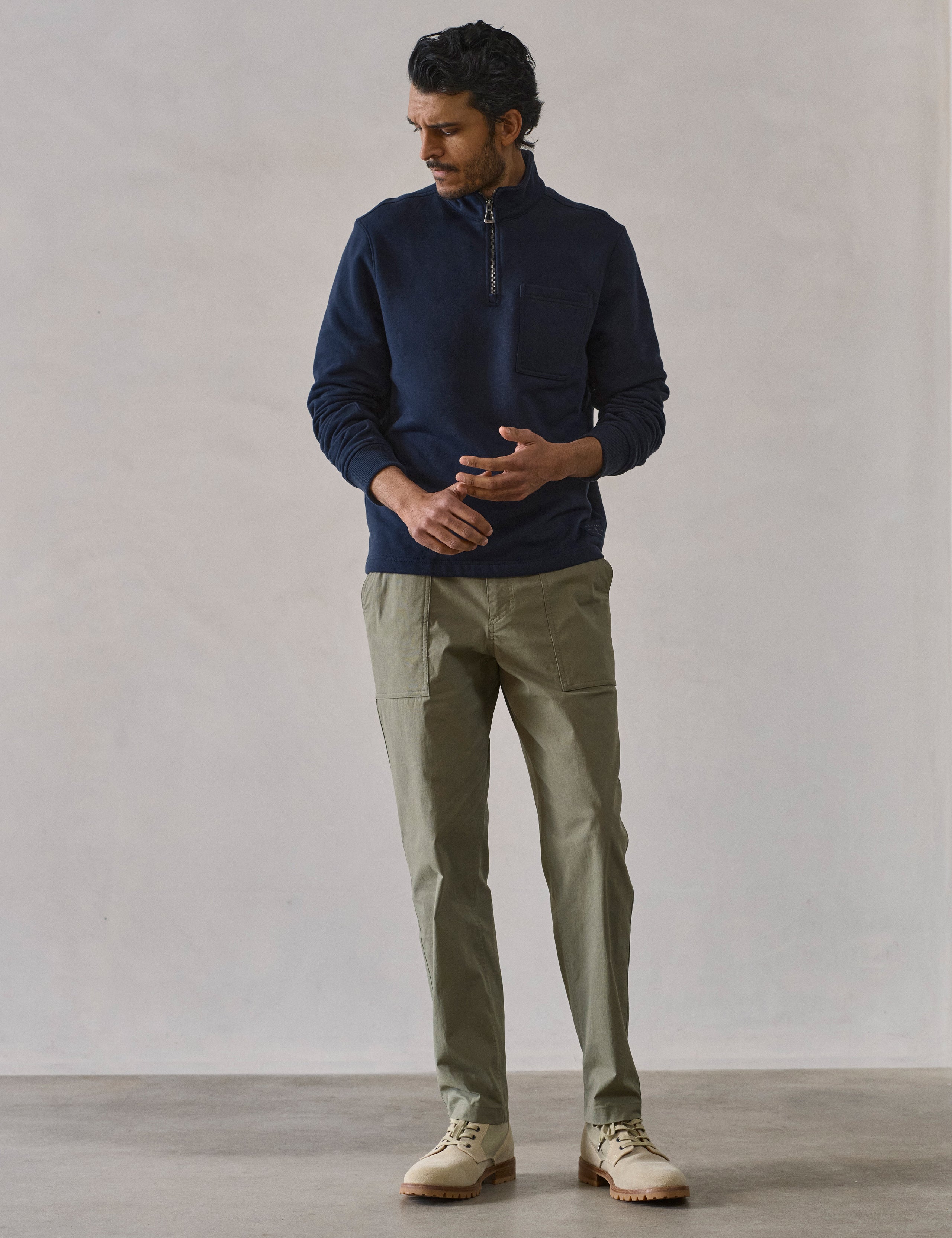 Front full-body view of man wearing Monte Half-Zip Sweatshirt in Total Eclipse dark blue from AETHER Apparel.