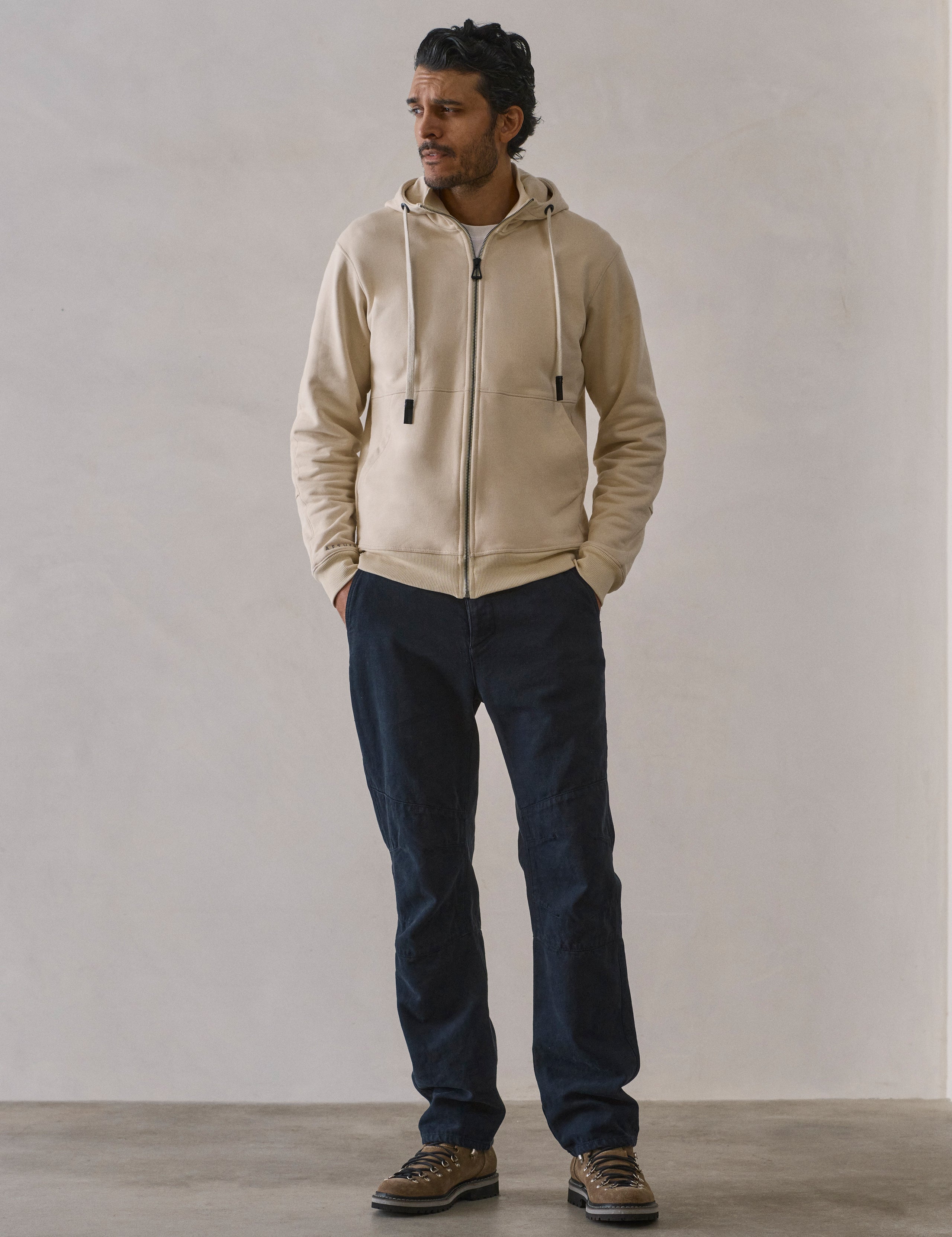 Front full-body view of man wearing Monte Full-Zip Hoodie in Bone white from AETHER Apparel.