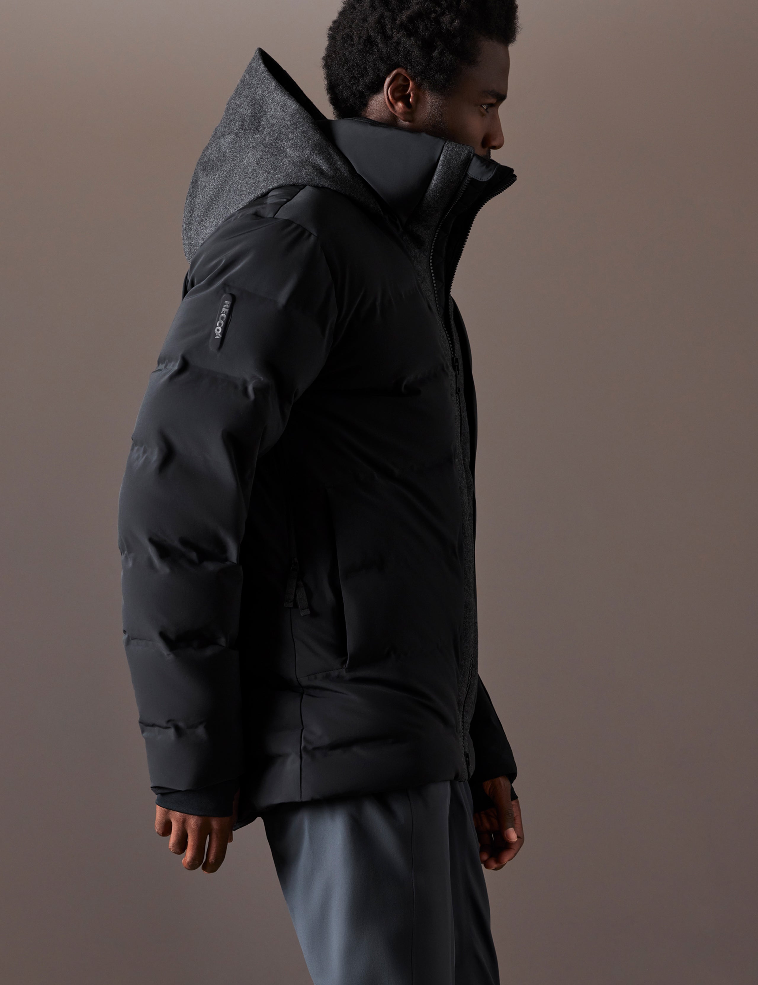 Right side profile body view of man wearing Nordic Jacket in Jet Black from AETHER Apparel.