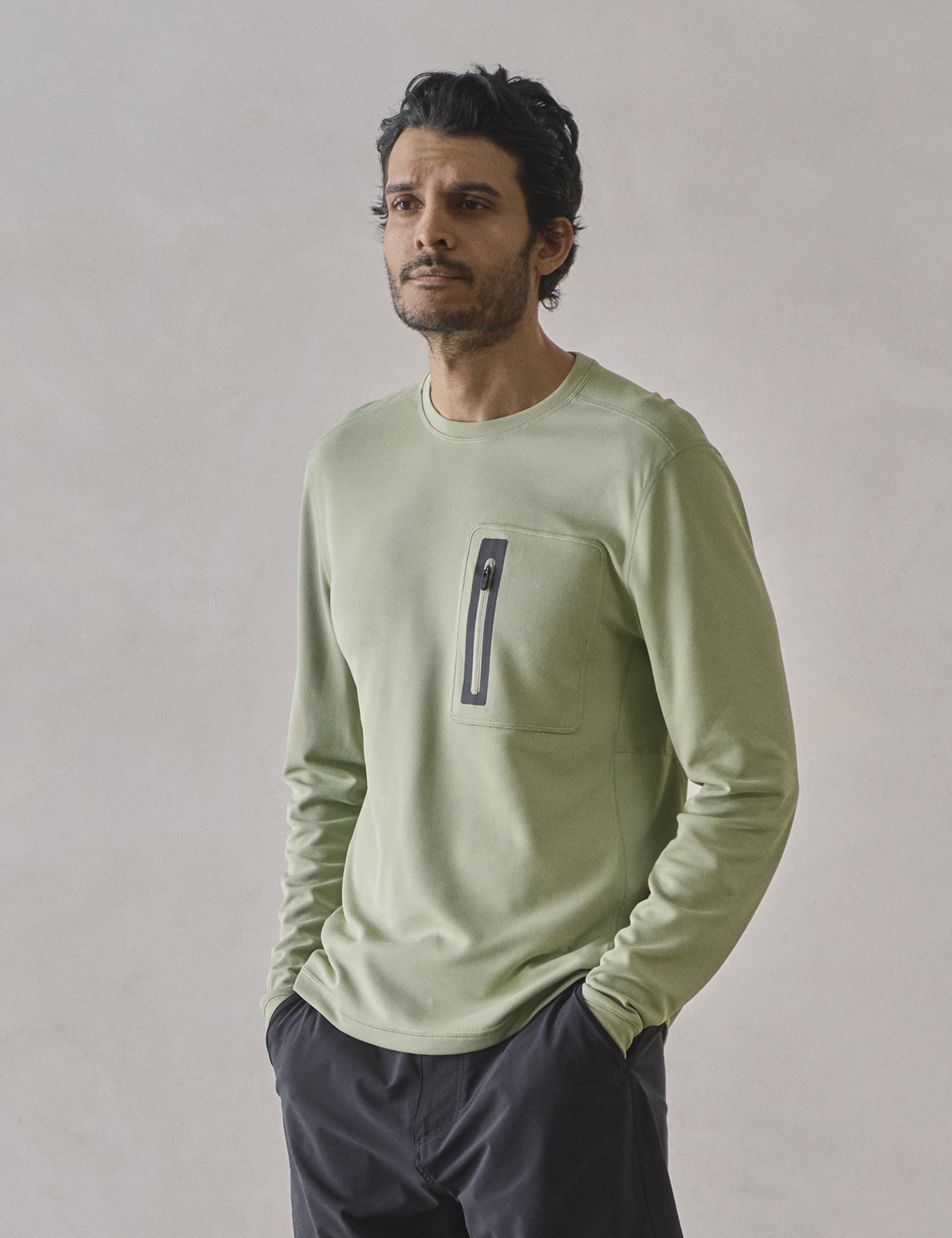 Front 3/4 upper-body view of man wearing Pacific Crewneck Sun Shirt in Sage Green from AETHER Apparel.