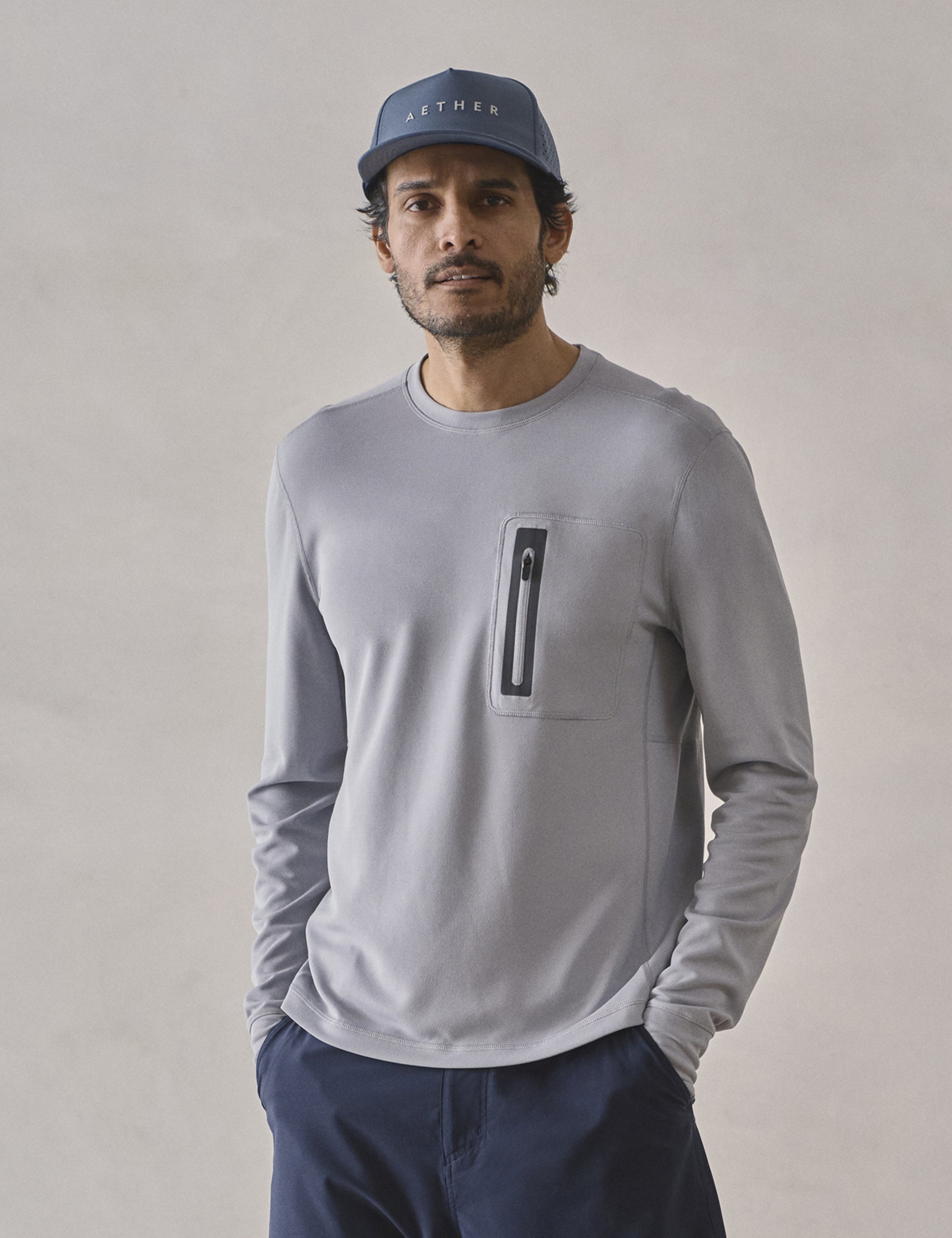 Front upper-body view of man wearing Pacific Crewneck Sun Shirt in Sky Grey from AETHER Apparel.