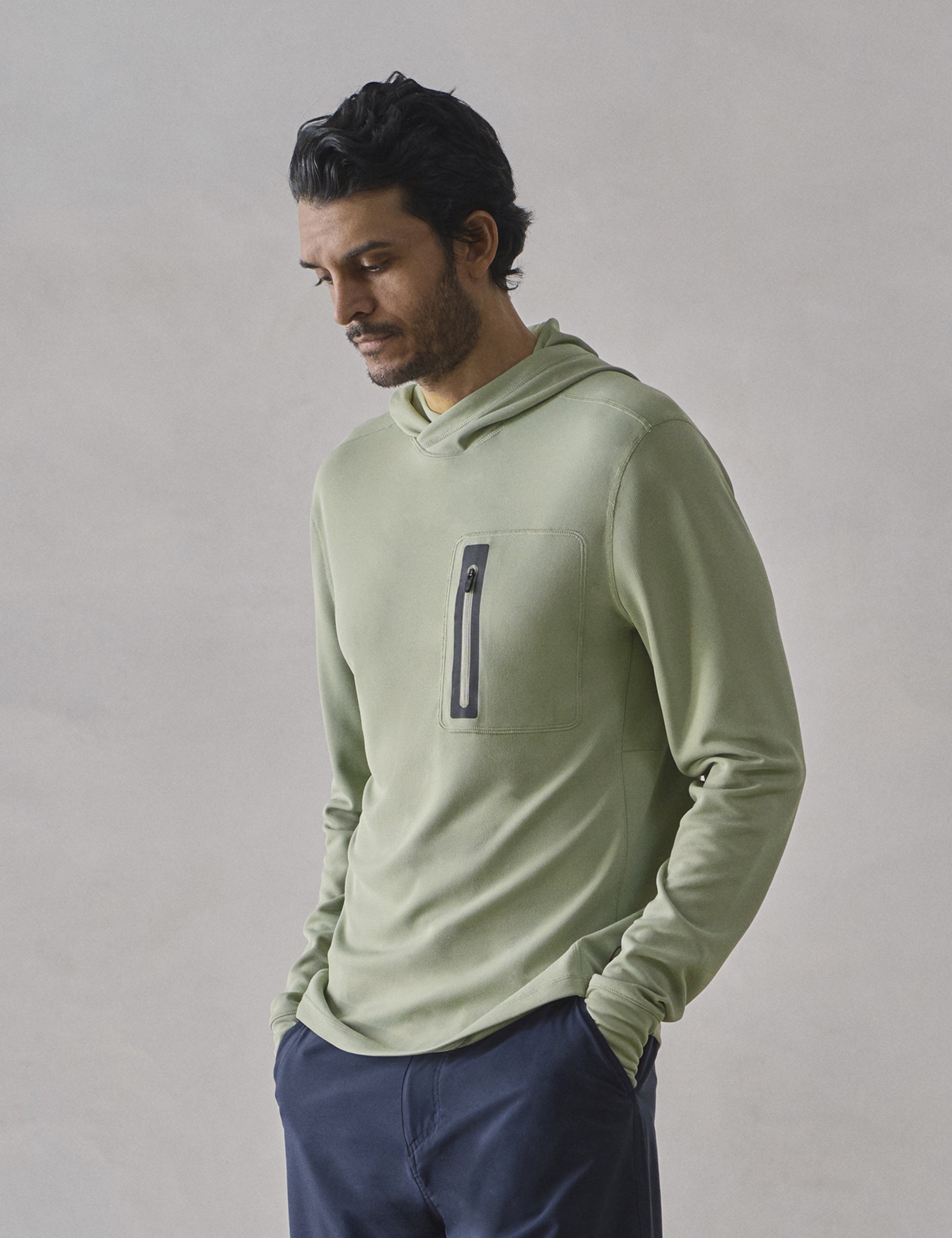 Front 3/4 upper-body view of man wearing Pacific Hooded Sun Shirt in Aqua Blue from AETHER Apparel.