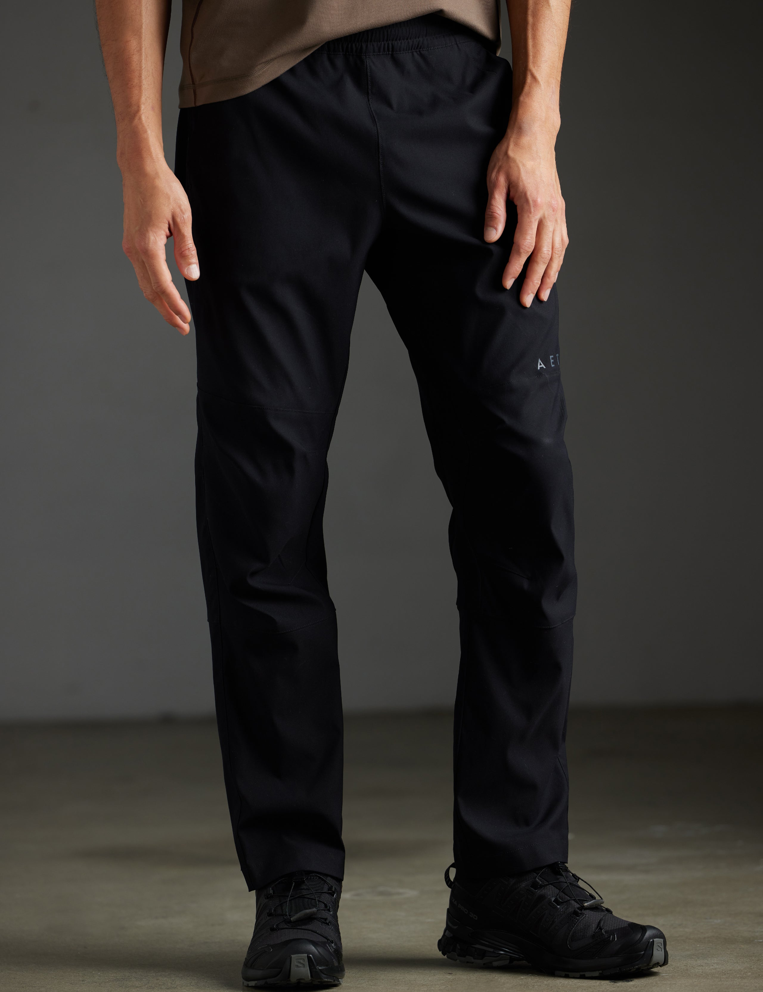 Front lower body view of man wearing Perth Pant in Onyx Black from AETHER Apparel.