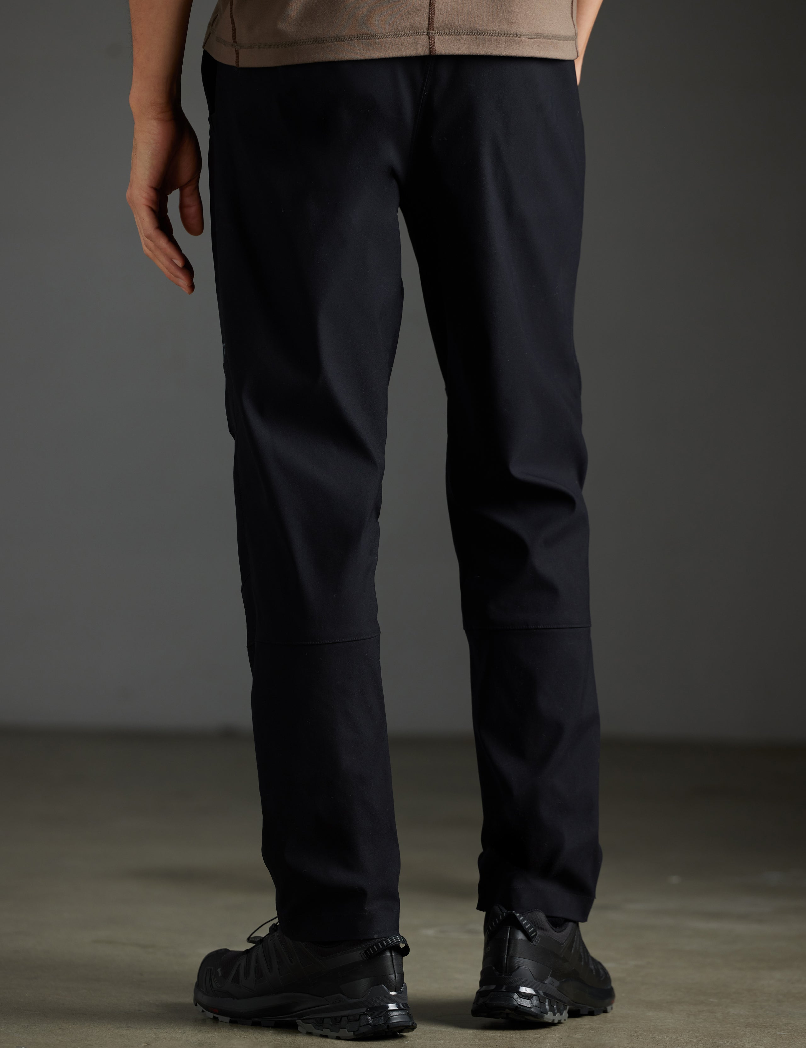 Rear lower body view of man wearing Perth Pant in Onyx Black from AETHER Apparel.