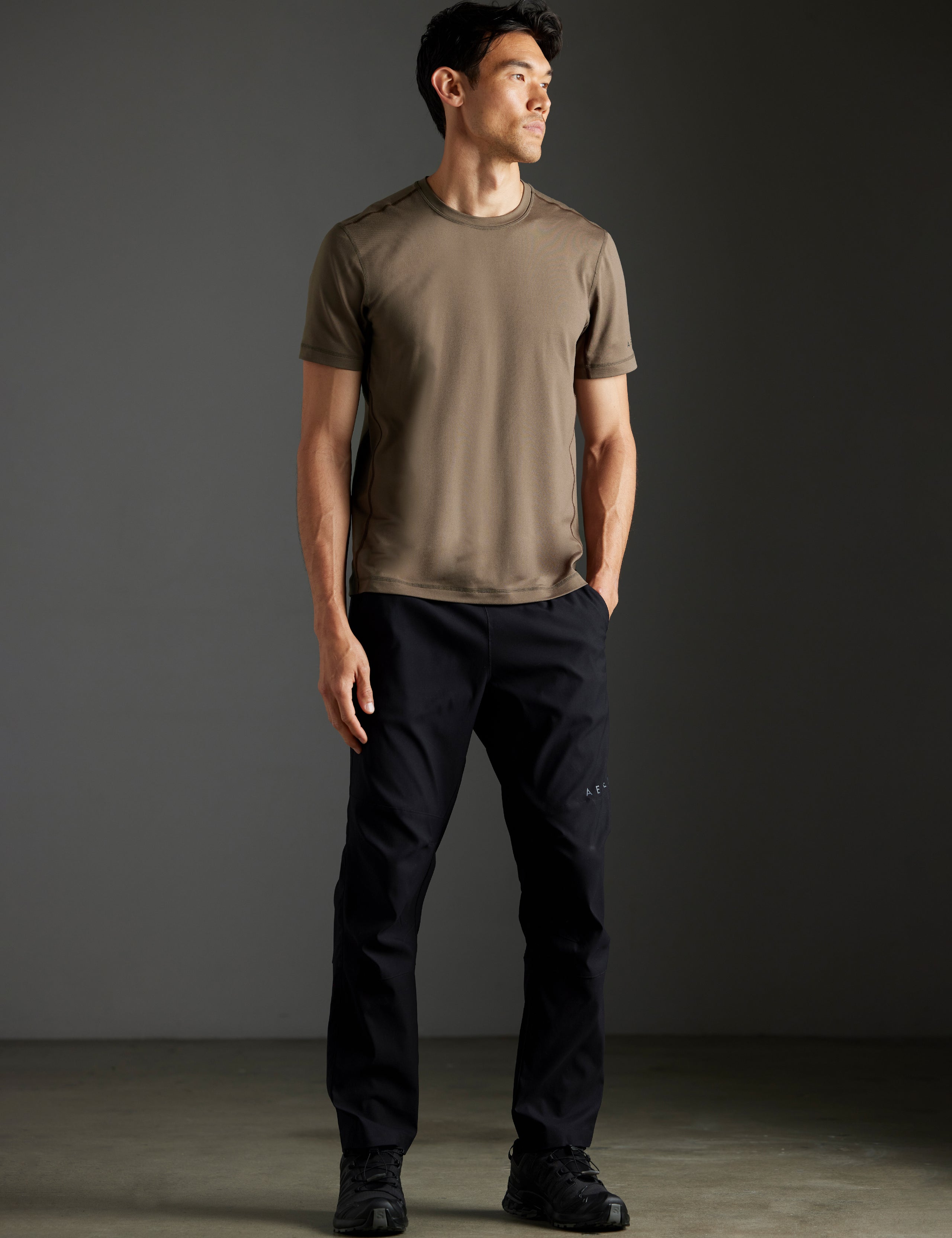 Front full-body view of man wearing Perth Pant in Onyx Black from AETHER Apparel.