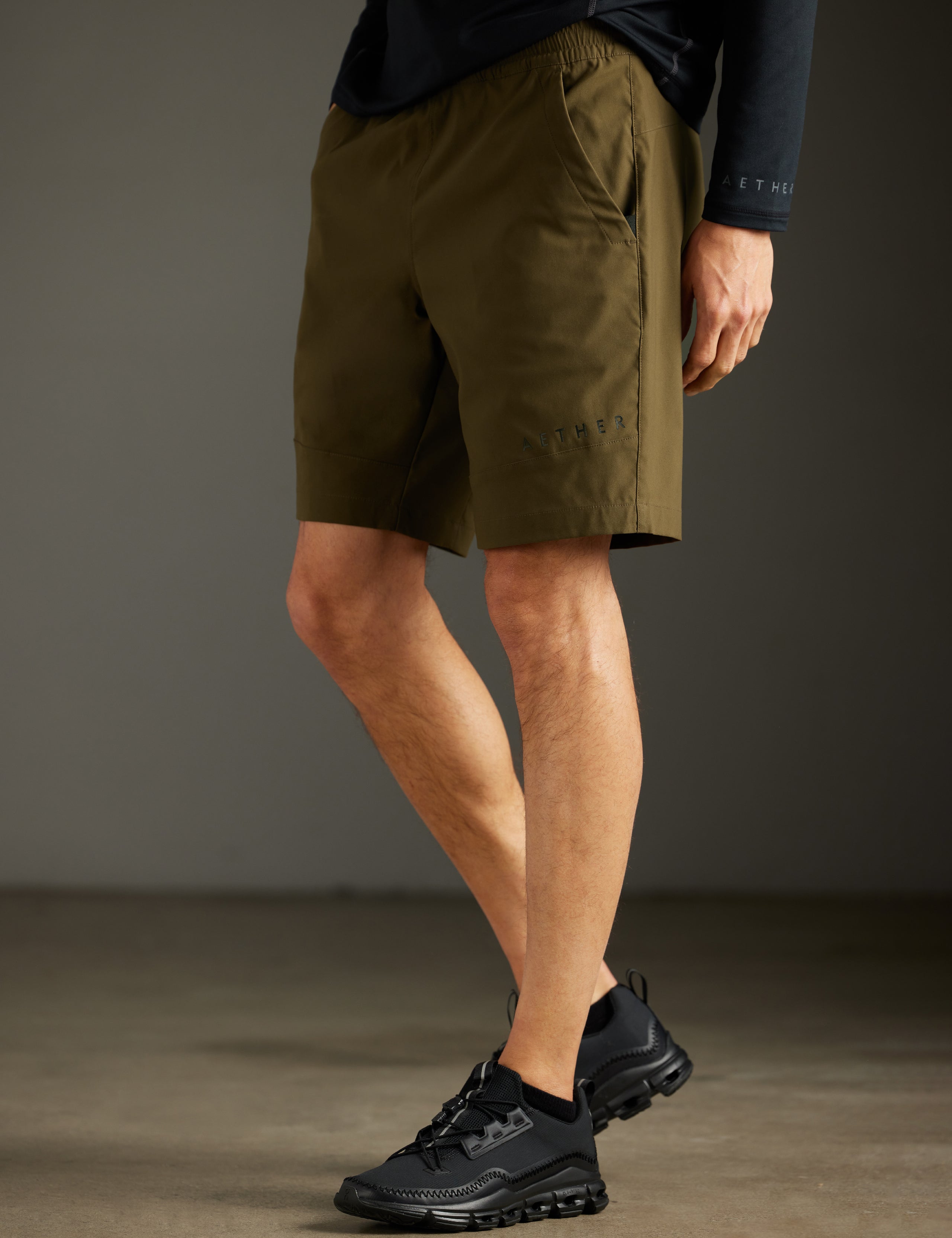 Front 3/4 lower body view of man wearing Perth Short in Cadet Green from AETHER Apparel.