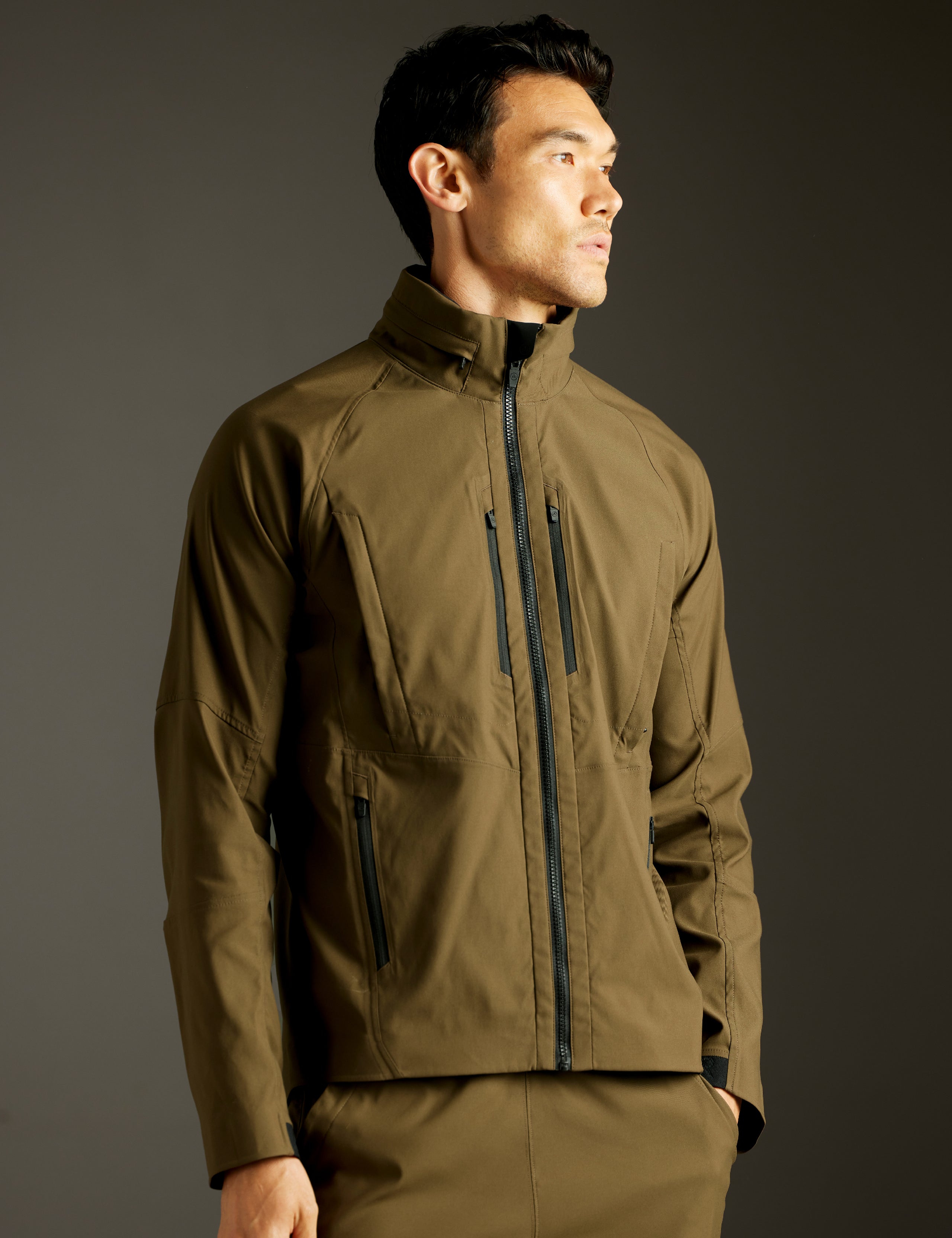 Front 3/4 body view of man wearing Perth Vented Jacket in Cadet Green from AETHER Apparel.