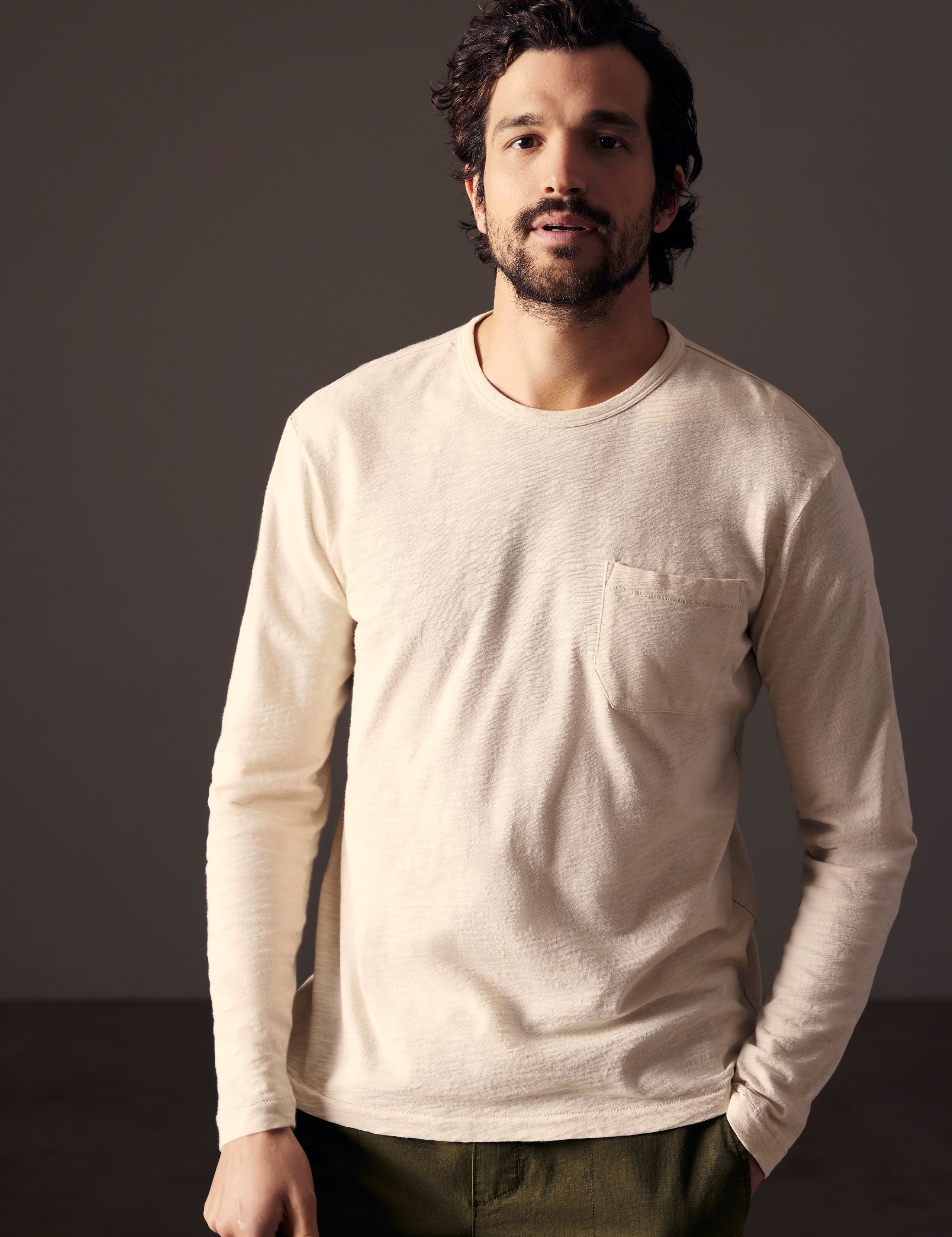 Front body view of man wearing Slub Long-Sleeve Tee in Bone white from AETHER Apparel.