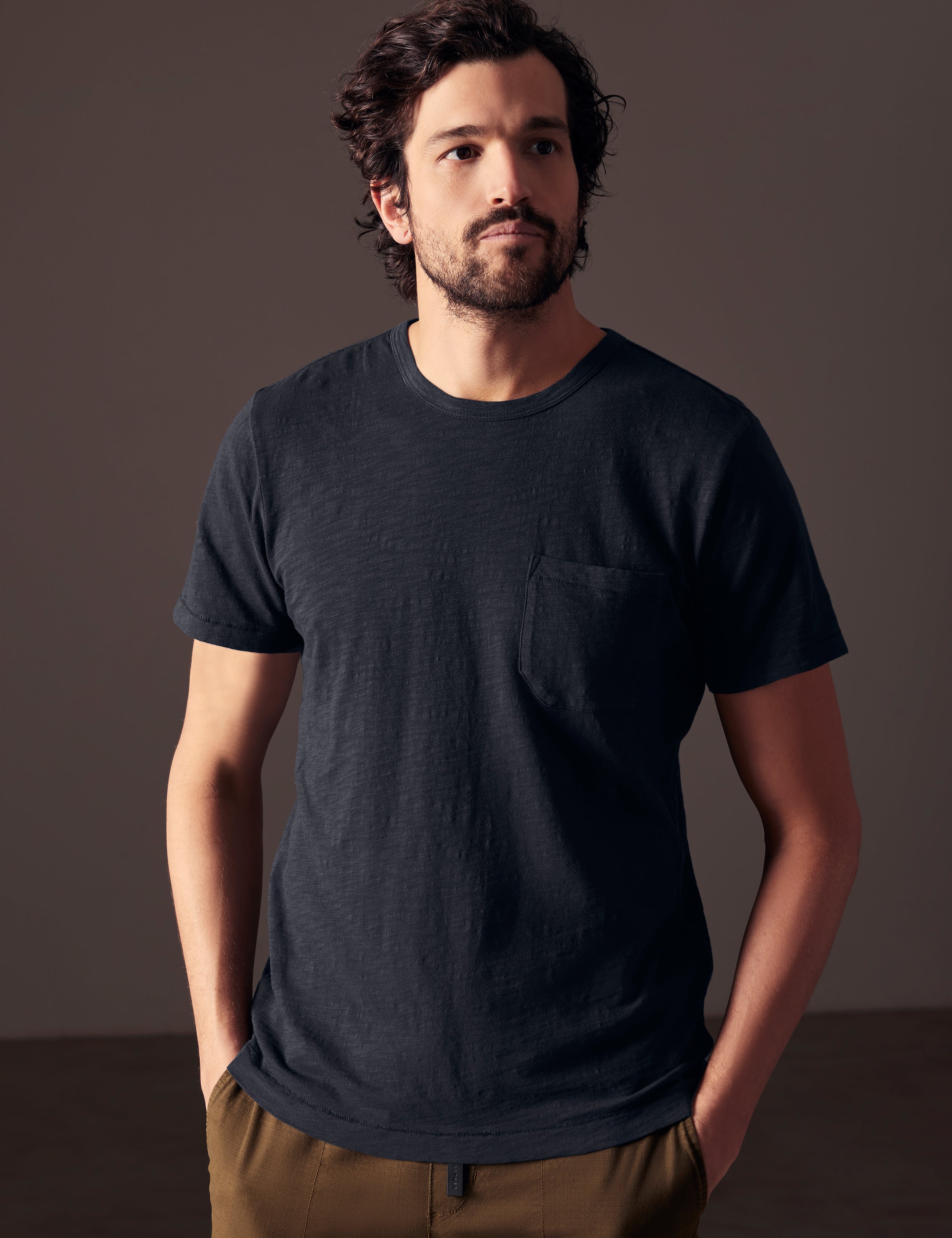 Front body view of man wearing Slub Pocket Tee in Total Eclipse dark blue from AETHER Apparel.