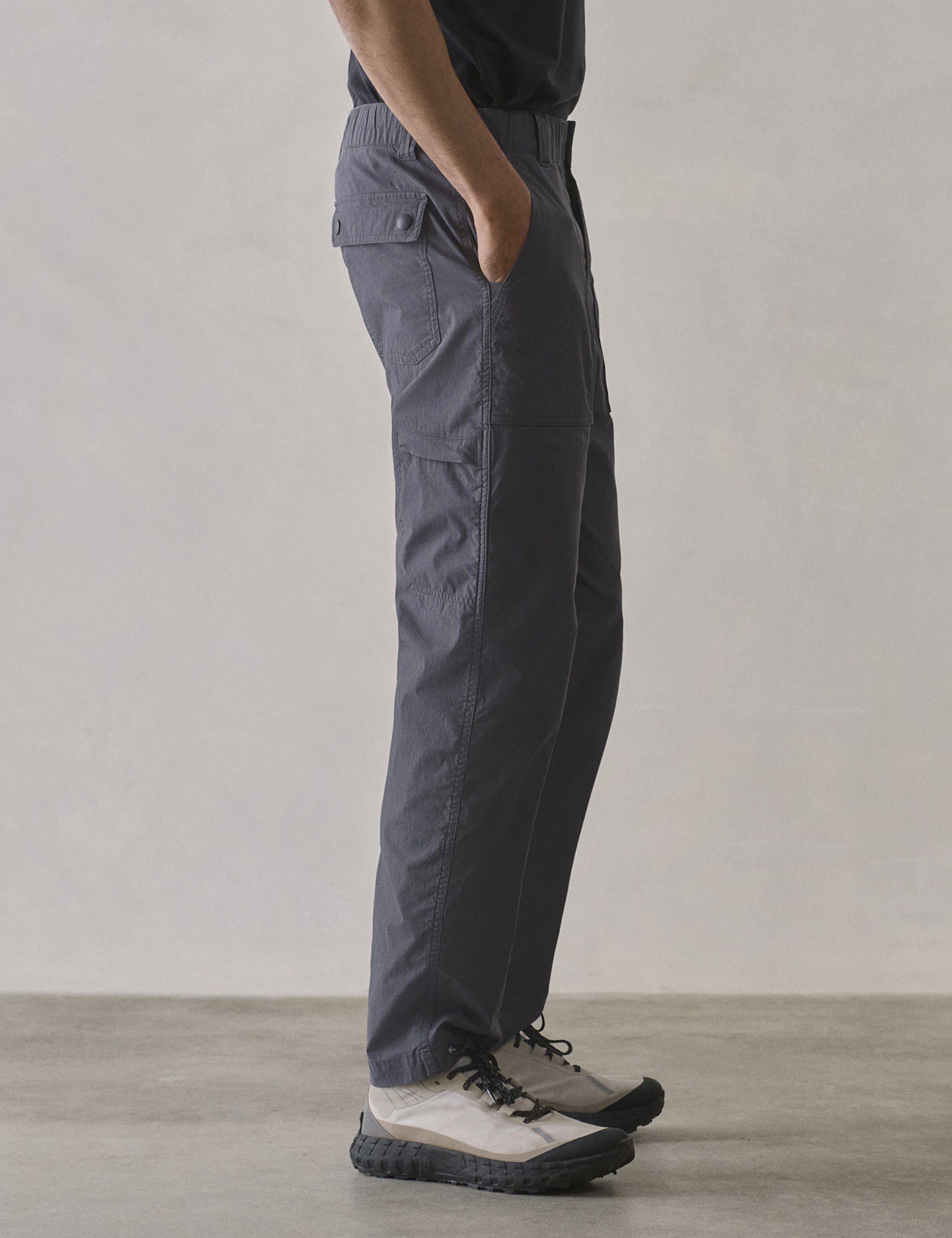 Side profile lower body view of man wearing Zermatt Hiking Pant in Graphite from AETHER Apparel.