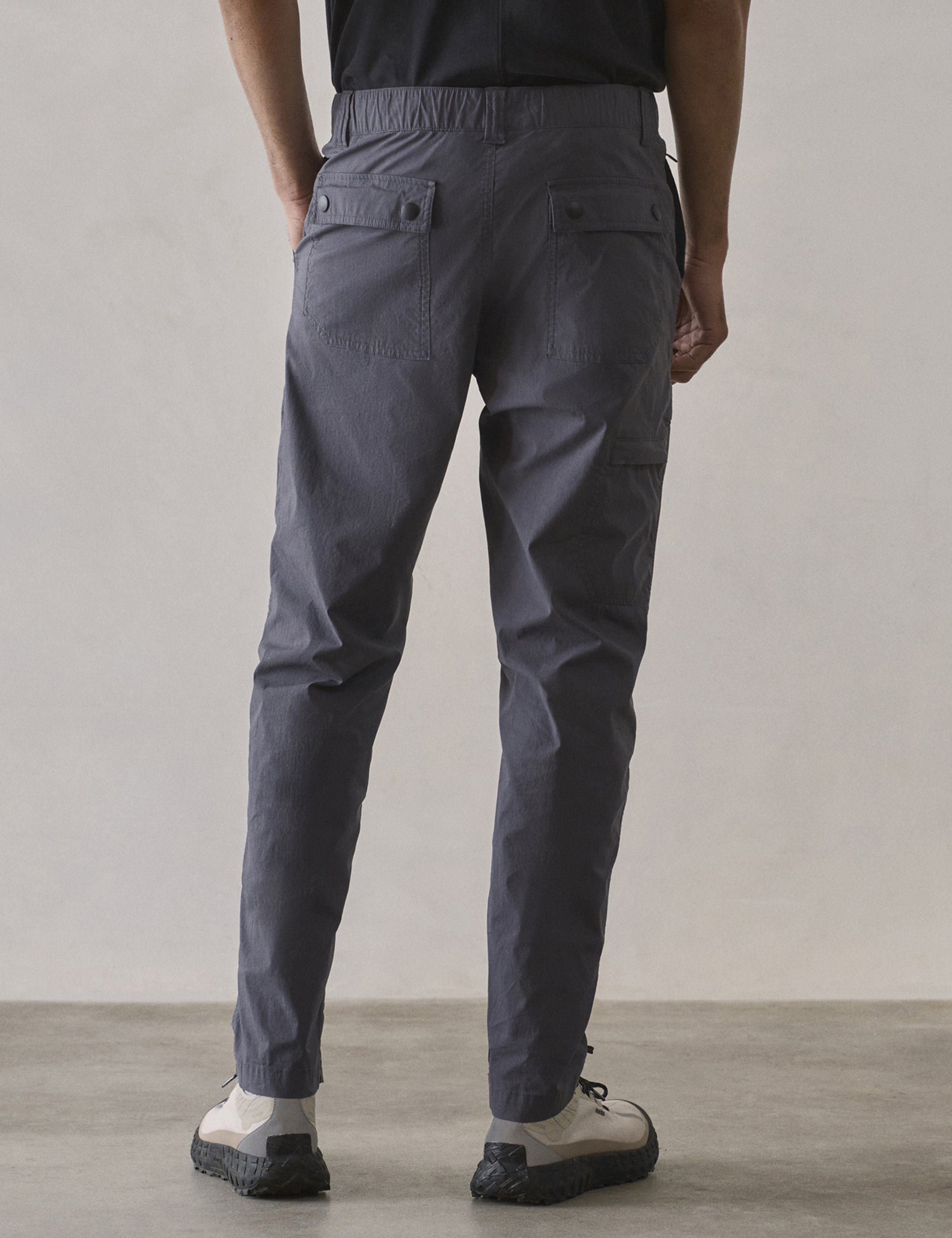 Rear lower body view of man wearing Zermatt Hiking Pant in Graphite from AETHER Apparel.