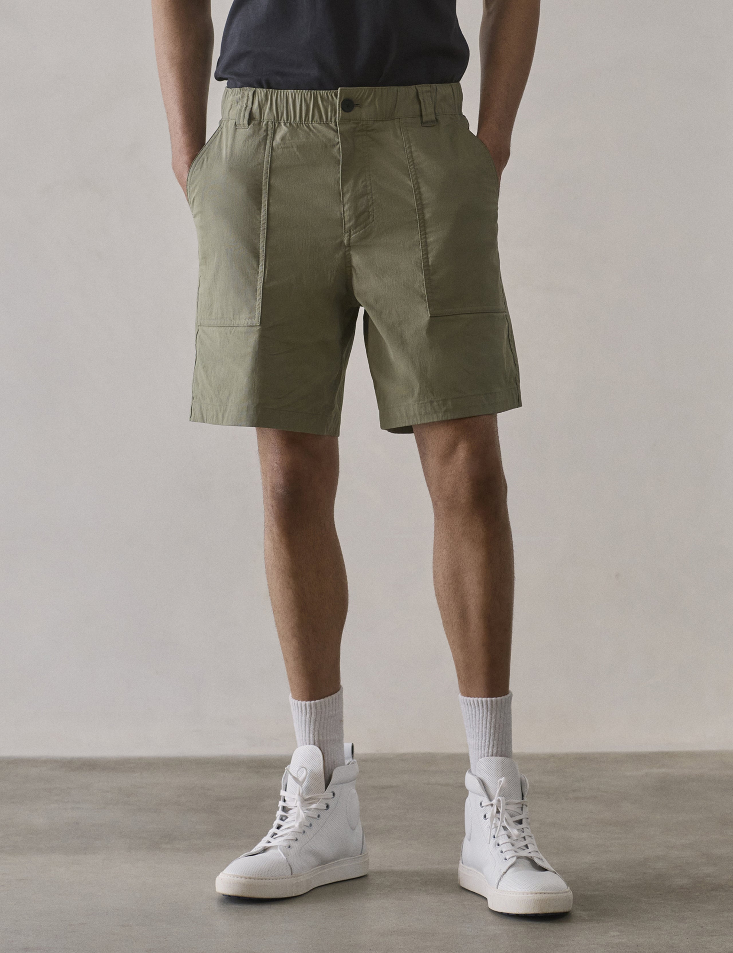 Front lower body view of man wearing Zermatt Hiking Short in Fern Green from AETHER Apparel.