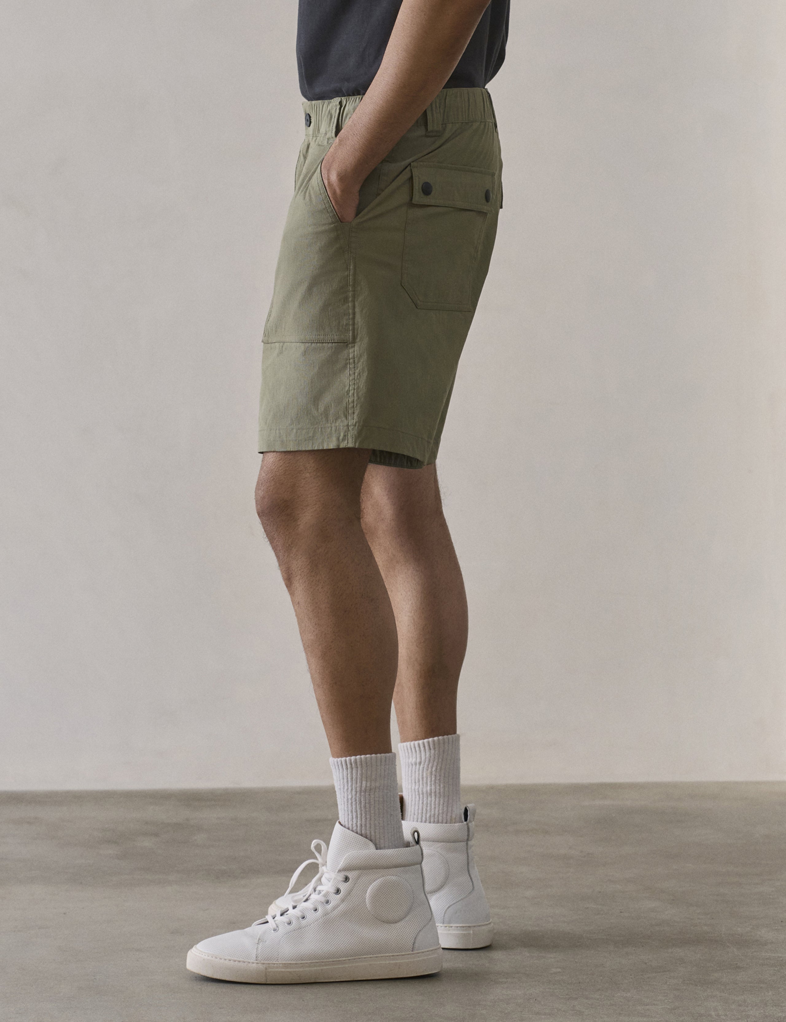 Side profile lower body view of man wearing Zermatt Hiking Short in Fern Green from AETHER Apparel.