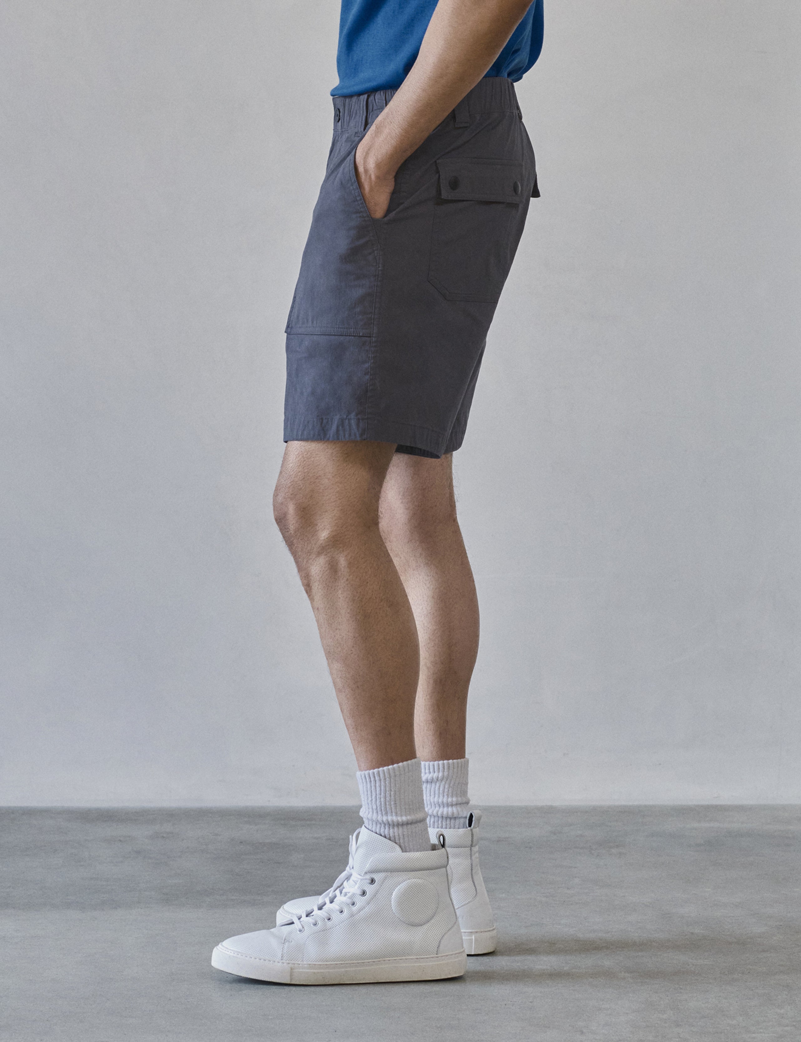 Side profile lower body view of man wearing Zermatt Hiking Short in Graphite from AETHER Apparel.