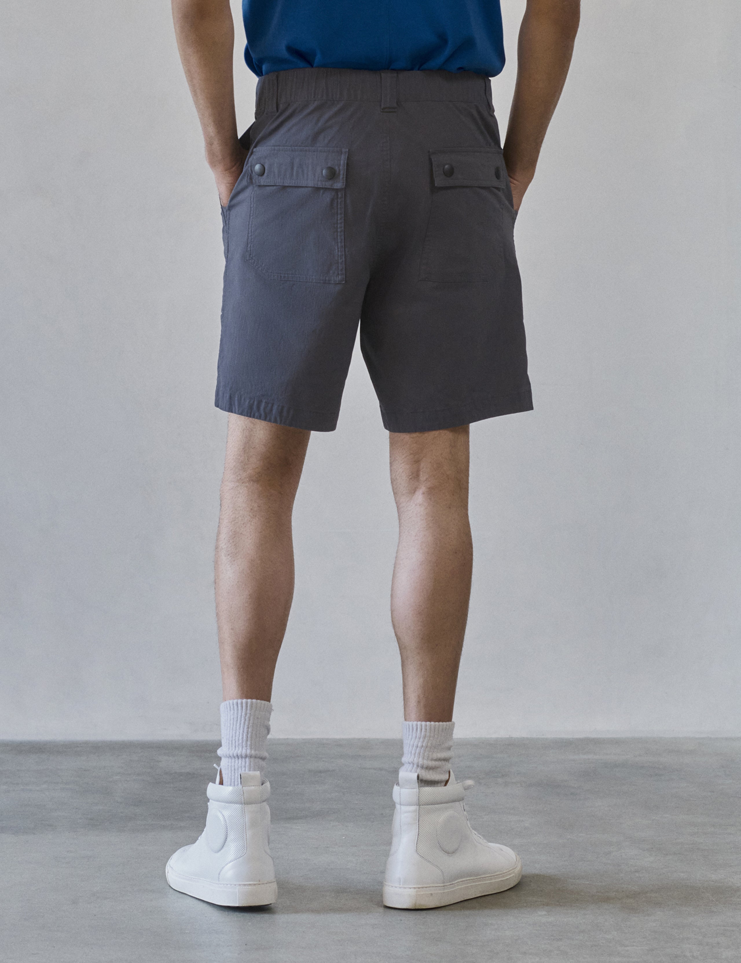 Rear lower body view of man wearing Zermatt Hiking Short in Graphite from AETHER Apparel.