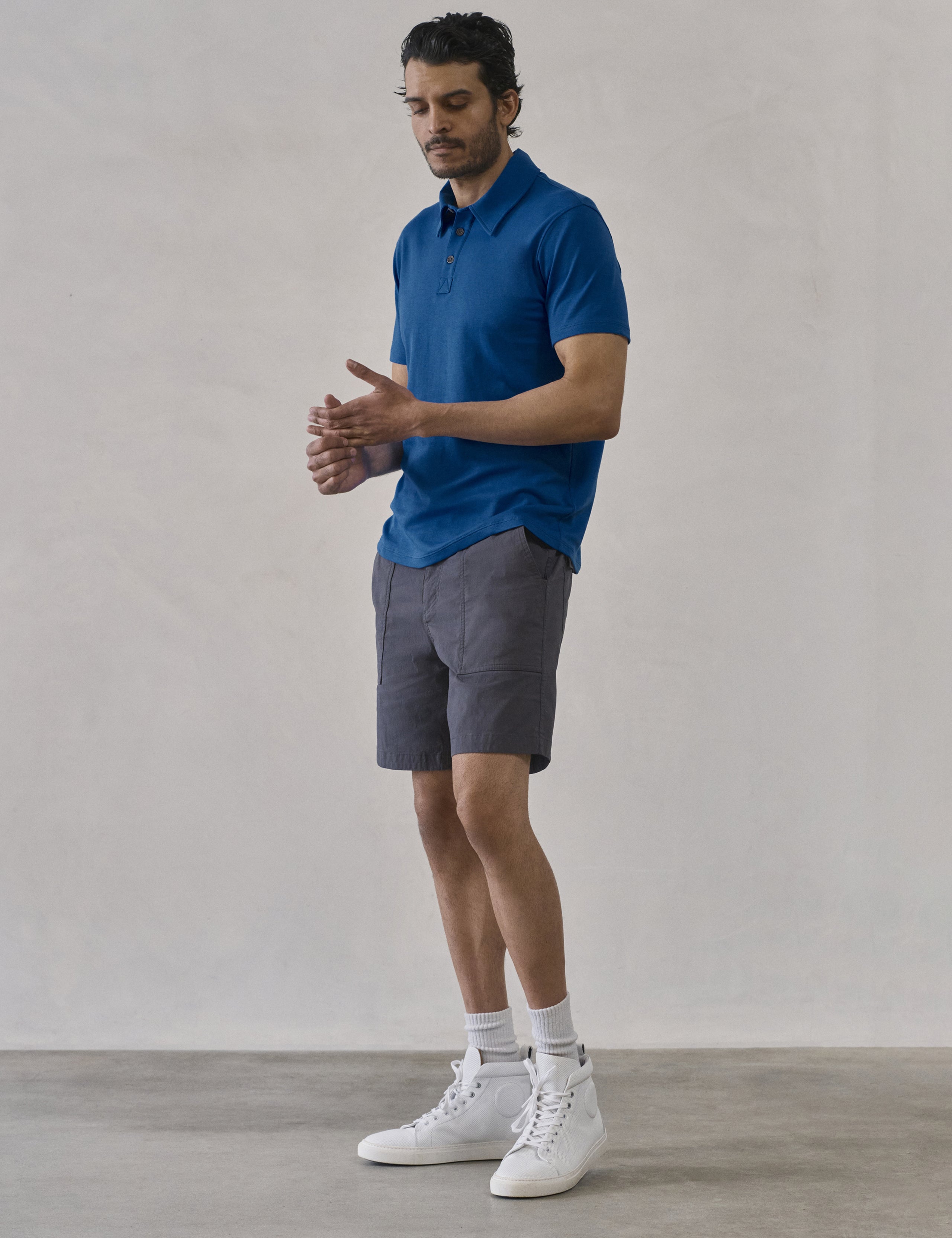 Front 3/4 full-body view of man wearing Zermatt Hiking Short in Graphite from AETHER Apparel.