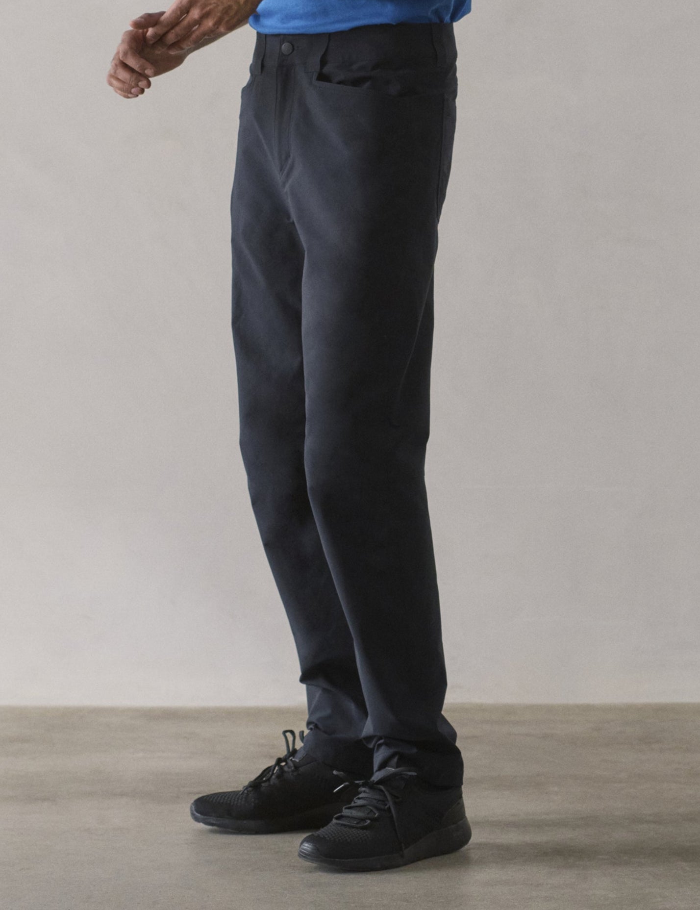 Front 3/4 lower-body view of man wearing Adventure Pant in Onyx Black from AETHER Apparel.