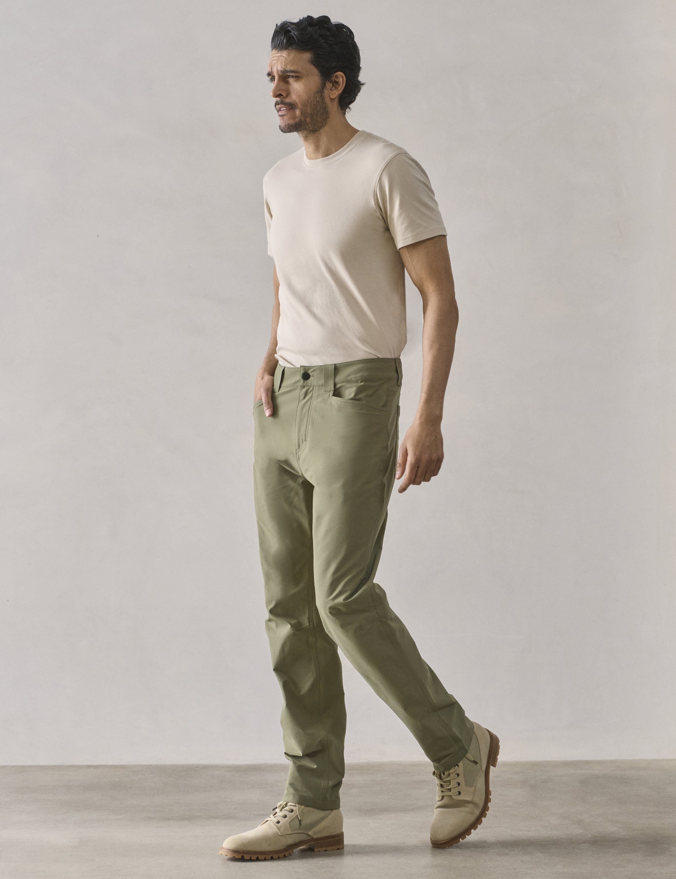 Front 3/4 full-body view of man wearing Adventure Pant in Fern Green from AETHER Apparel.