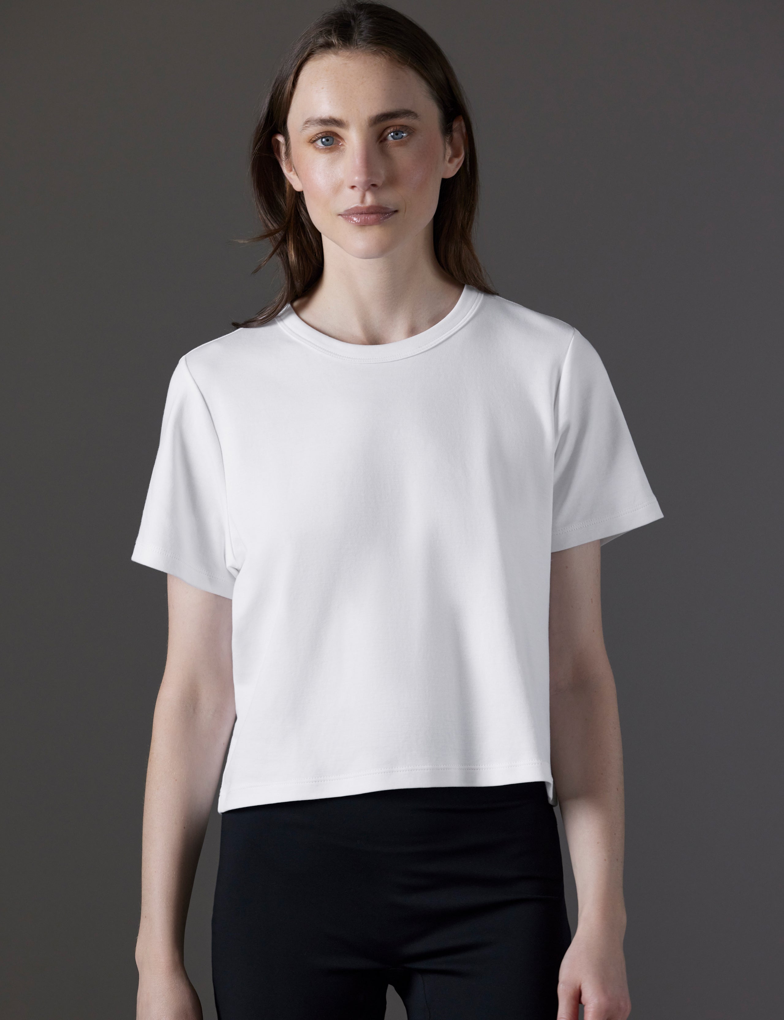 Front view of woman wearing Emery Pima Cropped Tee in White from AETHER Apparel.