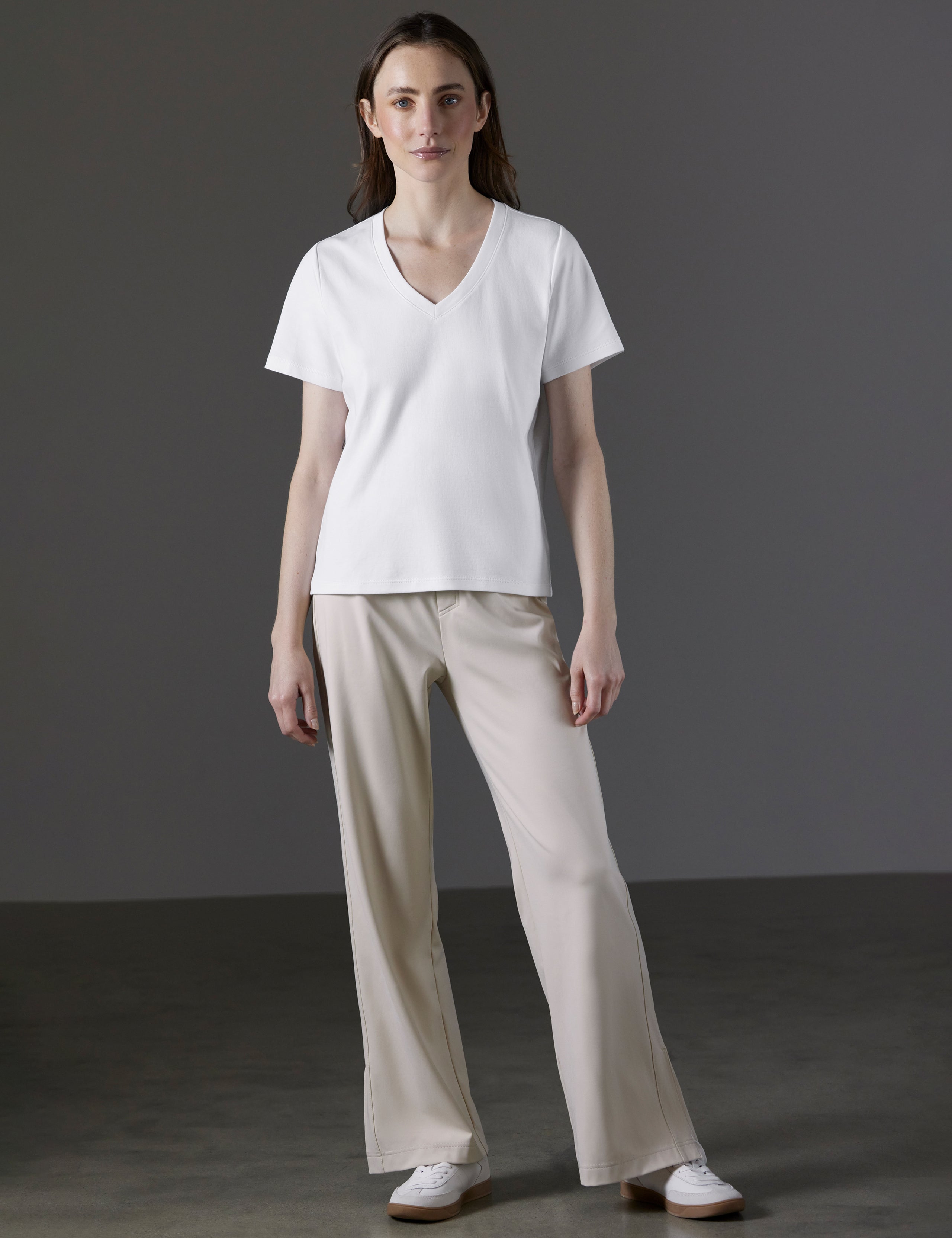 Front full-body view of woman wearing Emery Pima V-Neck Tee in White from AETHER Apparel.