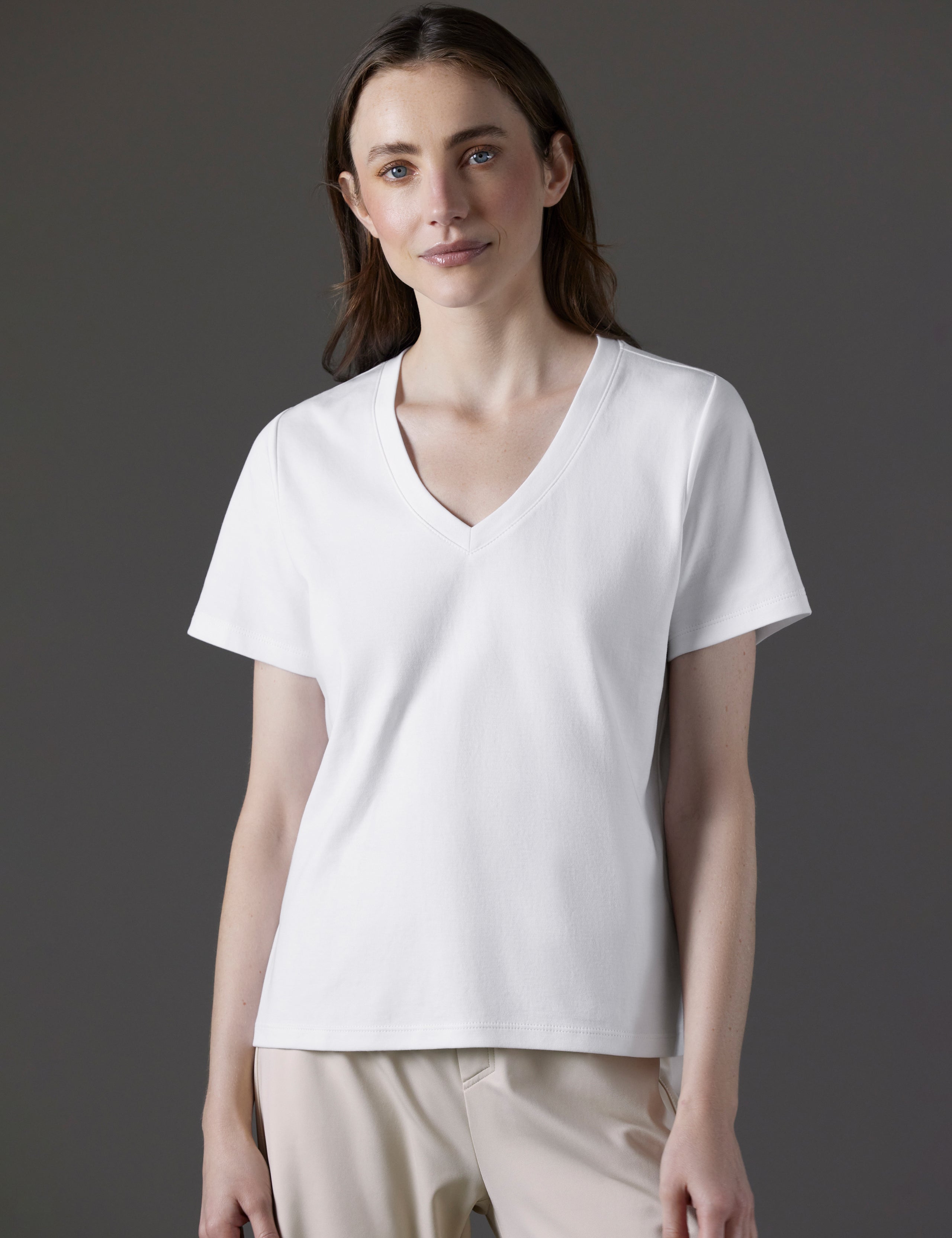 Front view of woman wearing Emery Pima V-Neck Tee in White from AETHER Apparel.