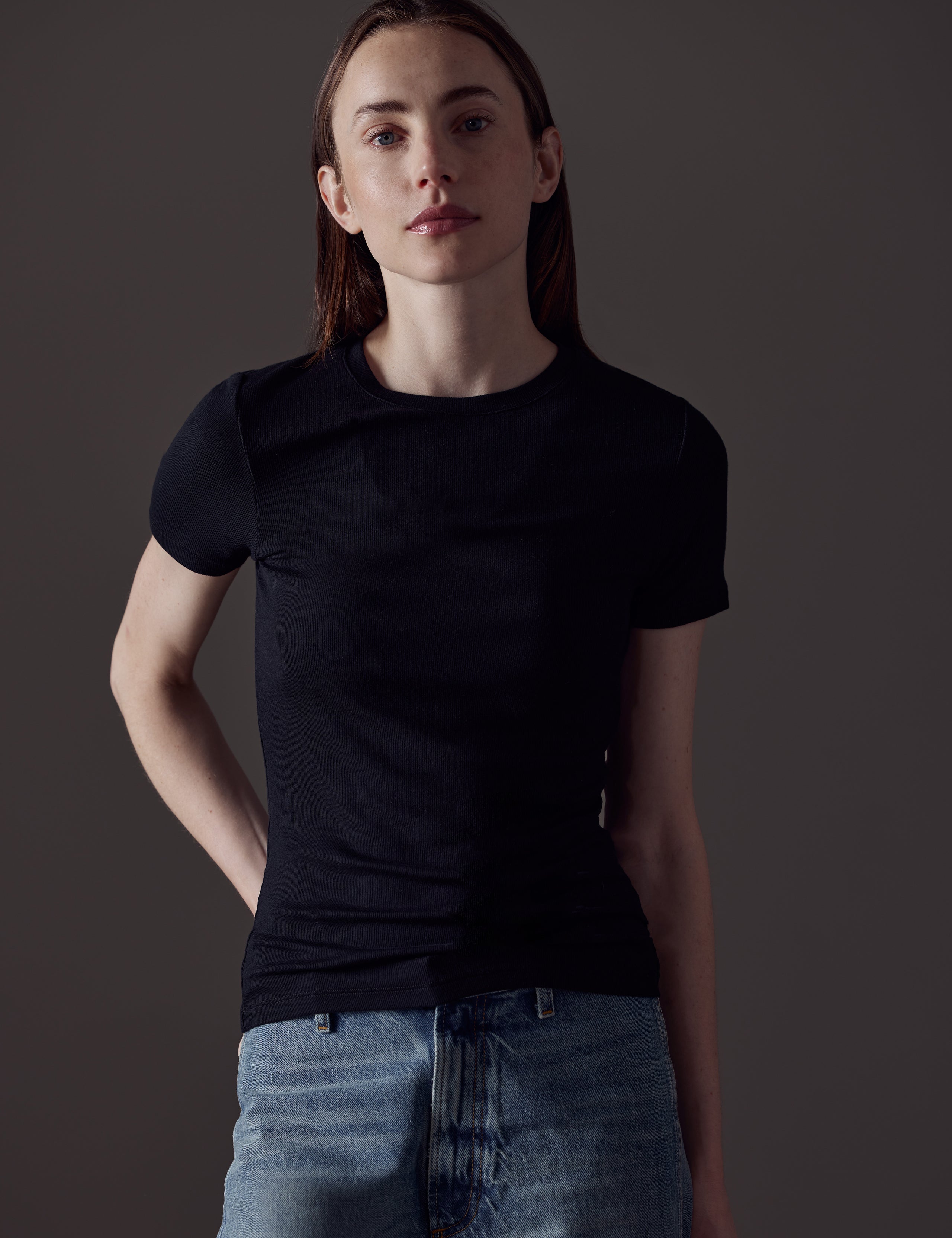 Front view of woman wearing Legacy Short-Sleeve Crew in Onyx Black from AETHER Apparel.