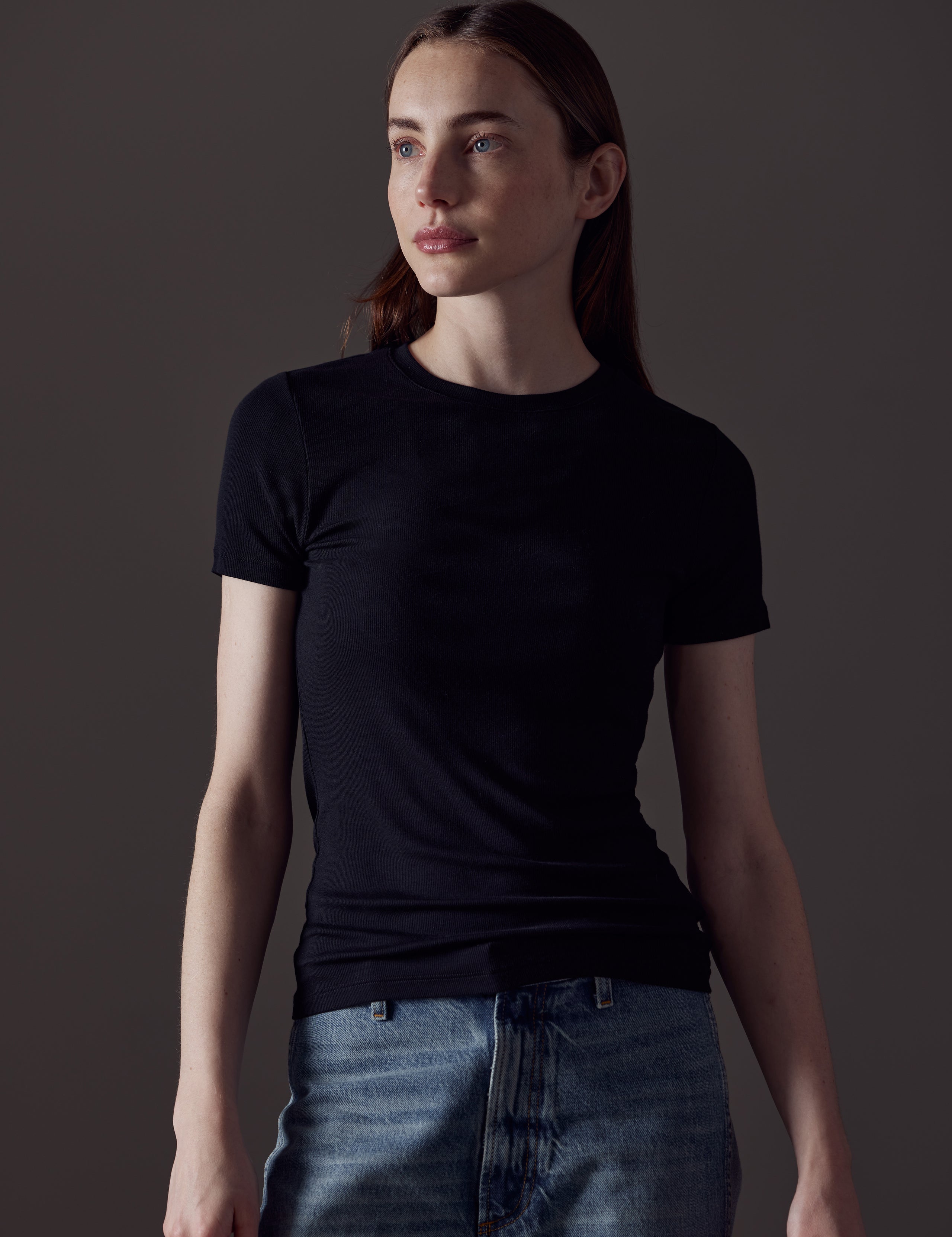 Front angled view of woman wearing Legacy Short-Sleeve Crew in Onyx Black from AETHER Apparel.